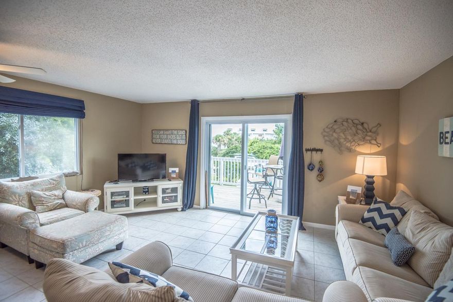 Blue Mountain Beach town home with a gulf view! Perfect location at a perfectly reasonable price. This 2 bedroom 1.5 bath town house comes furnished for you or your guests, decorated to make sure you feel like you are on vacation. One of the few units with a gulf view from both floors. Storage unit below can be added sq footage with some minor work. The Sandcastle community has a pool and only 1 block to the beach! You are located between the gulf and 30A and just a short stroll or ride to restaurants and shops. Wonderful family vacation spot without a lot of traffic.