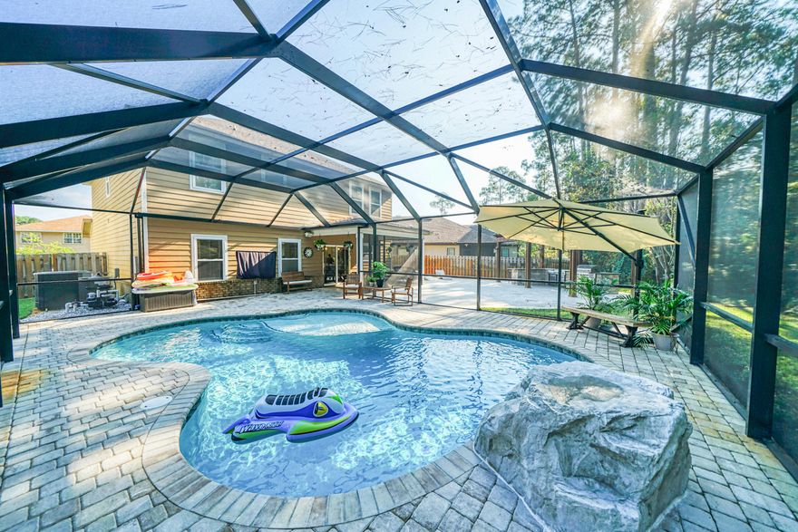 **BACK ON MARKET AT NO FAULT OF THE SELLER** Brand new heated pool - Summer lasts all year long here!  This amazing 5 bedroom home has everything you want and need including an amazing outdoor kitchen and screened in pool with water feature!  New shiplap, lighting, and featuring gorgeous granite throughout, this well thought out floor plan has so much room for everyone.  Roof installed in 2015, Water heater 2015, HVAC #1 2015, HVAC #2 2014, active termite bond with Arrow and is transferable, pool under warranty and transferrable, survey available, flood insurance required but current rate is $600/year.  Buyer to verify all information deemed important.