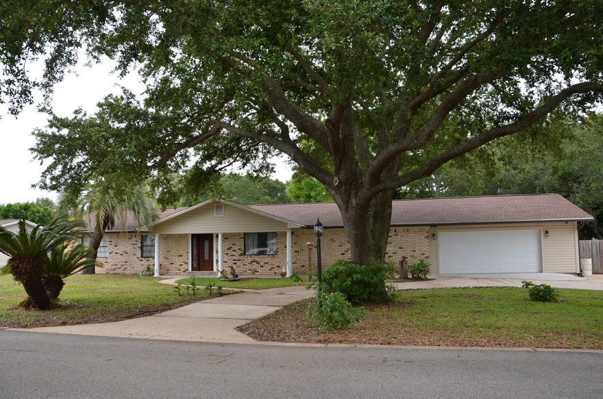 PRICE REDUCED! Located in an established subdivision with low traffic in West Destin, this home is perfect for entertaining family and friends. It includes a modern kitchen with granite countertops, lots of lighting, and plenty of room for moving around. Kitchen is also equipped with a wine refrigerator and several cabinets. The sliding glass doors and large window in the living room provide natural light and sunshine. The living room also has an electric fireplace, built-in counter space, and two closets with shelves. Spacious utility room includes ceiling fan with light, washer/dryer, utility sink, and more. The utility room leads to the 2 car garage, workshop, and backyard with tile patio. If you are looking for a home in a great location and plenty of storage space- look no further!