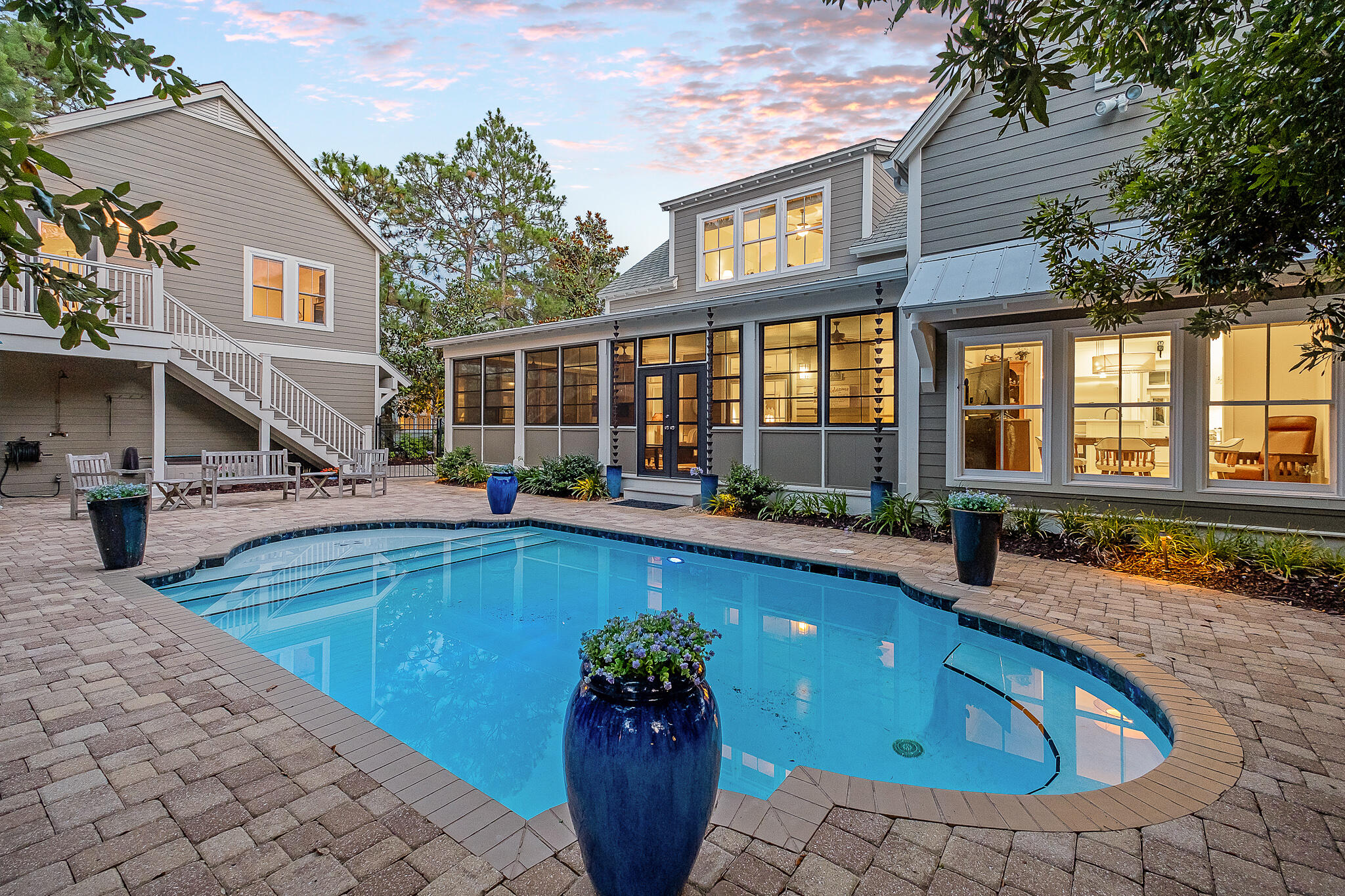 Stunning Southern Living inspired design on a spacious lot with private pool in the highly coveted community of Sugarwood in Seagrove. This single owner home has never been rented and has been meticulously maintained by it's full time residents. Mature landscaping and trees welcome you as you pull in to the driveway. A separate detached garage with finished room above would make for an easy carriage house conversion, while currently serving as a home gym. The main house contains a thoughtful concept that blends indoor and outdoor living with it's large wrap-around screened porch extending out to the heated pool and paver deck. Enjoy an open concept living/kitchen with a plethora of built-ins. The adequately stocked kitchen features a Thermador 6 burner gas cooktop, Bosch dishwasher,
