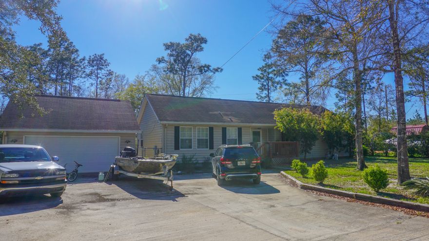 NO HOA!!!!! 3-2-Detached two-car garage. Fenced backyard with partially covered decking. Beautiful Wood flooring in entry, living area, and dining area. Great bar for entertainment with great open light area in great room, dining and kitchen with windows across the back of the house looking out on the double deck on .8 acres.