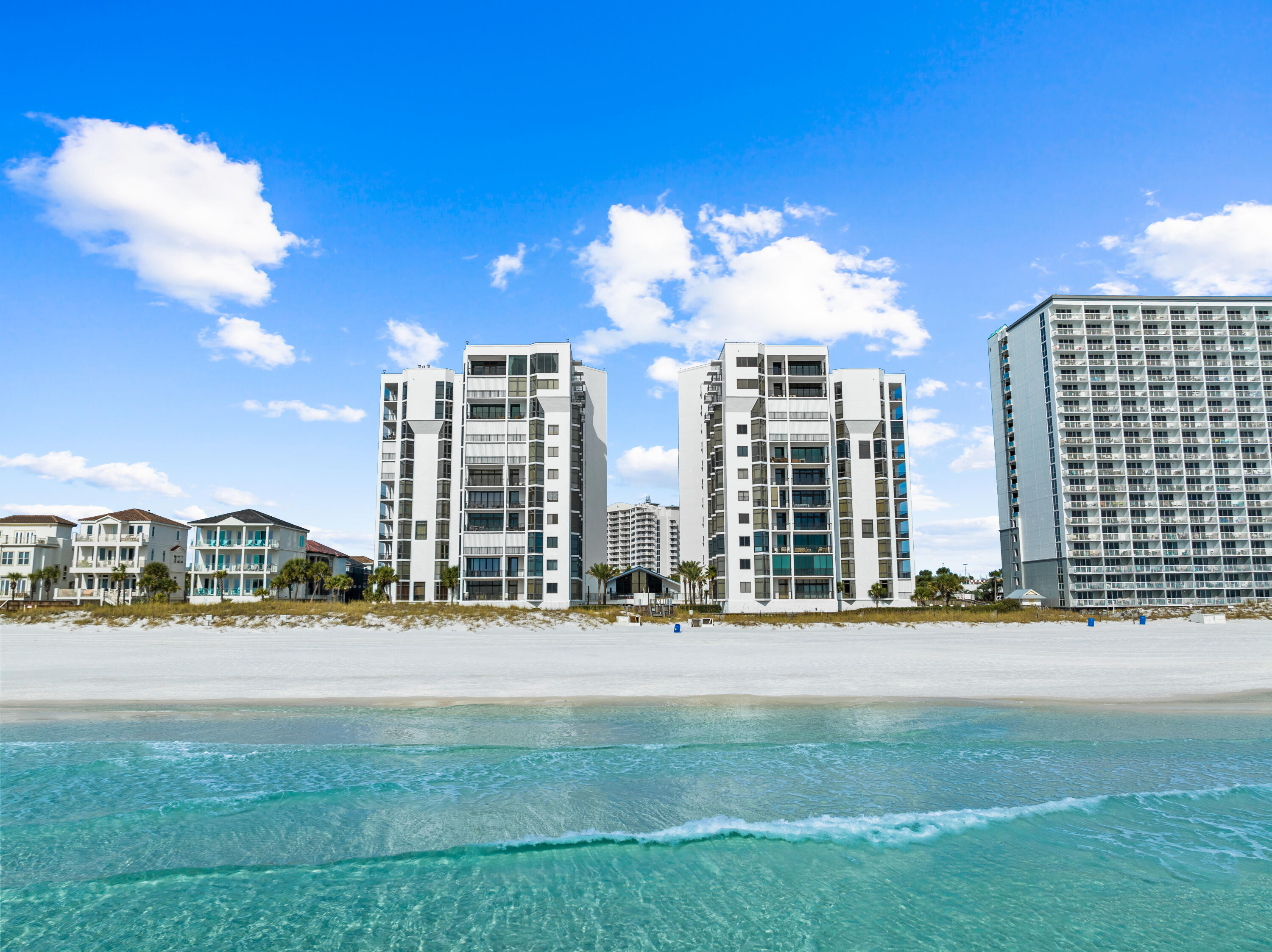 This impressive gulf-front three-bedroom residence sprawling half of the 10th floor is the epitome of private coastal living and has been recently refreshed by the team at Lusso Interiors. The expansive main living and dining areas offers sweeping 180-degree views of the turquoise hued waters effectively blurring the line between indoors and out A beautifully remodeled chef's kitchen encompasses custom cabinetry, dual kitchen islands, sleek quartz countertops, and luxury appliance package. Step out to the expansive, nearly 300SF balcony which is the perfect place to admire the new palate of mesmerizing hues emitted by the renowned Emerald Coast sunsets each night. Synonymous with relaxation, the bright and airy main suite is a true oasis boasting floor to ceiling windows with gorgeous gulf views , a seating area, nook for a desk area, and dual walk-in wardrobes. The sumptuous ensuite features dual vanities, a soaking tub and a separate walk-in shower. Flooded with natural light, the two junior suites are each generous in size, boasting two queen-sized beds, beautiful views and are paired with spa-like en-suites and walk-in wardrobes, with one offering a private terrace overlooking the Dunes of Destin Lake and surrounding topography.
When it comes to ultra-luxe Gulf front living, the allure and stature of Regency Towers remains unrivaled. The intimate non-rental community is tucked away behind the private gated entrance and bordered by lush vegetation reigning on nearly five acres and over 300 feet of private beach frontage. The sought-after low density complex affords residents with world-class amenities including concierge services, on-site security, covered parking, club house, game room, fitness center, dual saunas, pool, pickle ball court, basketball court, shuffleboard, private beach frontage, and a dedicated climate-controlled storage area for each residence. Inquire today to arrange a private viewing and start living the coastal lifestyle you deserve!