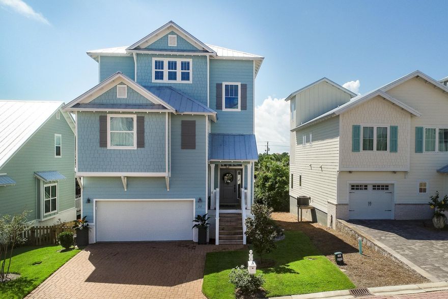 This beautiful 3 story home nestled between Camp Helen State Park, Lake Powell and the Gulf is the perfect location to experience all the Emerald Coast has to offer! You are within half a mile to the largest beach access in Walton County! This home features luxury finishes and details throughout. Tray ceilings, hardwood floors, crown molding, and 3 levels of covered decks with great views make this home a must-see. As you walk through the front door you will notice a split level floorplan boasting an incredible exposed stairwell opening up to all 3 floors. The living room and kitchen on the 2nd floor feature large windows providing lots of natural light.