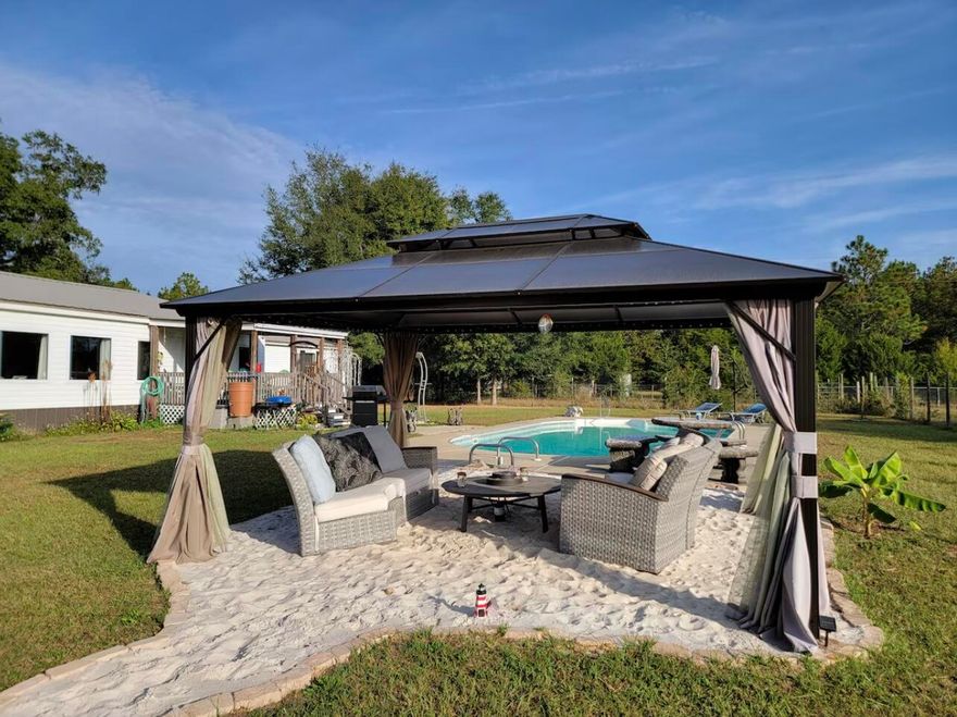 4-Bed, 3-Bath home on 1.09 Acres with Pool and Income-Producing! This is perfect for families or investors! Featuring an open floor plan, spacious kitchen, private primary suite, and a fenced-in pool, it's ideal for relaxing or entertaining. The carport and large lot offer plenty of space for parking, play, or future expansion. Currently used as a successful short-term rental, this property is move-in ready. Enjoy country living just 10 minutes from I-10.