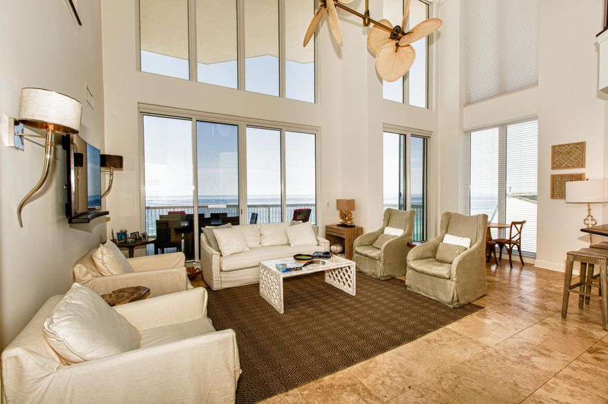 Enjoy soaring gulf front views through floor to ceiling glass in the two story great room of this exclusive newly remodeled/furnished private residence Silver Beach Towers Penthouse. Two gulf front master bedroom suites, three additional bedrooms with loft family room and separate dining room. New features include travertine and hardwood flooring, upscale lighting fixtures and chandeliers, new paint,new wall mounted smart tv's , retooled kitchen cabinets with glass doors and over and under LED lighting.Closet converted to game room.Wine refrig. New upscale designer furniture, furnishings,art and household items.. New patio furniture for all three terraces. This 3860 SF home conveys furnished with exception of some wall art. 2 car garage. 3 terraces. A must see for the discerning buyer.