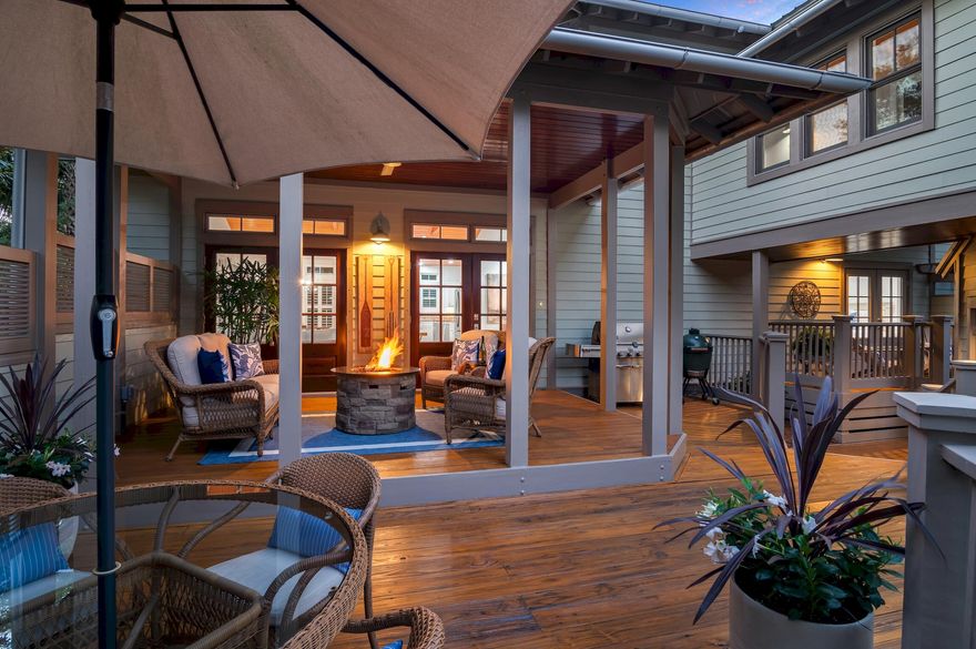 Located in the serene and exclusive gated enclave of Summer Ridge, this exquisite coastal cottage stands as a rare opportunity, epitomizing luxury and elegance. Surrounded by lush greenery, the setting evokes a sense of seclusion akin to living amid the treetops, offering a private, tranquil retreat.As you pass through the private courtyard, experience a tropical escape, with multiple decks and covered porches featuring an inviting fire table; perfect for both relaxation and hosting gatherings. This retreat welcomes you with french mahogany doors leading into an interior bathed in natural light. Vaulted wood-beamed ceilings, large windows, and freshly finished hardwood floors throughout.