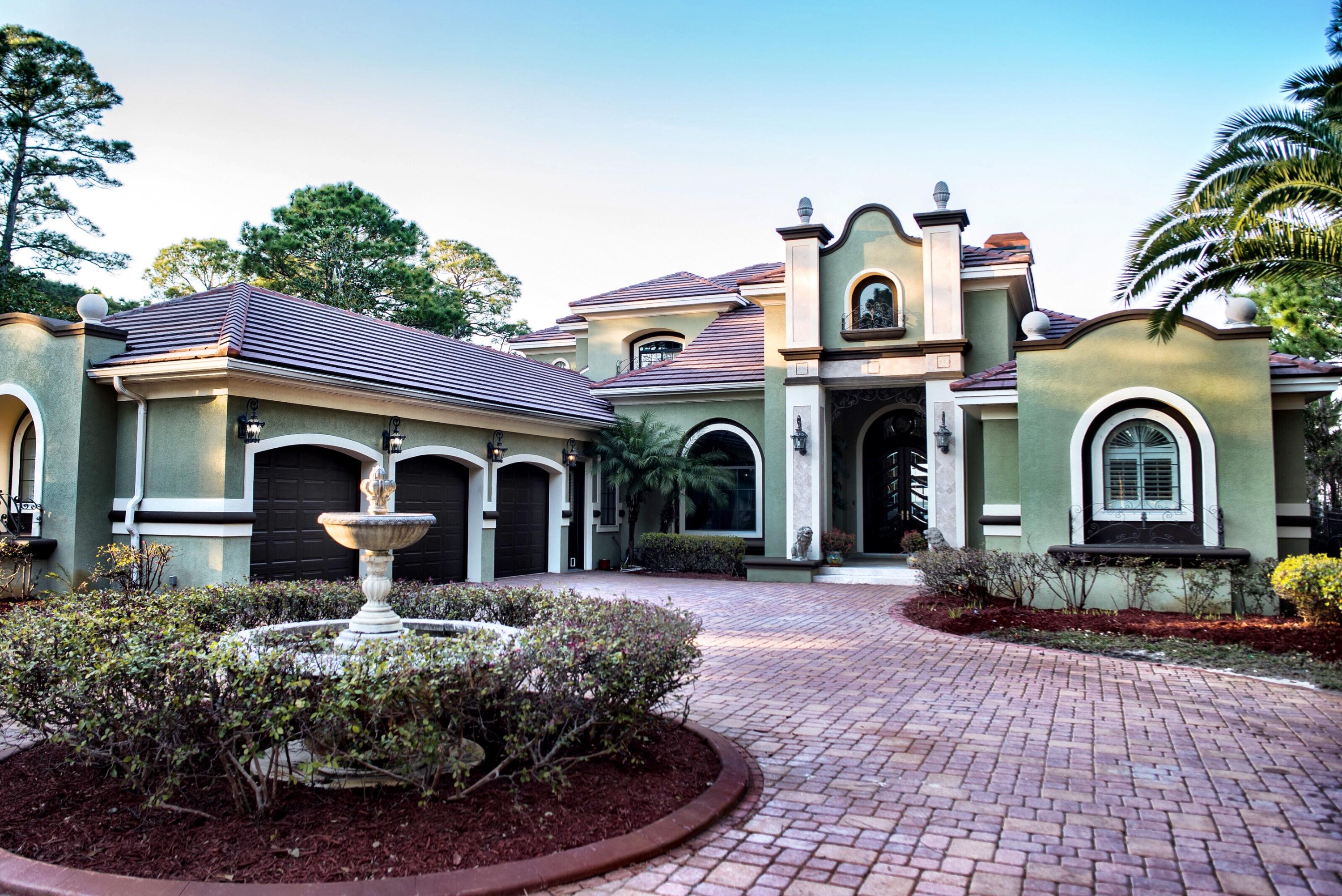 La Ventana is a spectacular gated bay front estate! There are so many custom features in this home that it simply must be seen to be appreciated! Once through the gated entry, a brick paver driveway with a showpiece center fountain leads to the house. The house greets you with an impressive entrance of stone inlayed columns & metal arches, and custom designed 14'' Honduran Mahogany & beveled glass doors that give your visitors the first view of the Bay.The foyer opens to the great room which features a stunning bay view through a large mitered structural glass window and the first of many fireplaces through the home. Just off the great room is the formal dining room which has hardwood floors & hand painted trayed ceilings.
