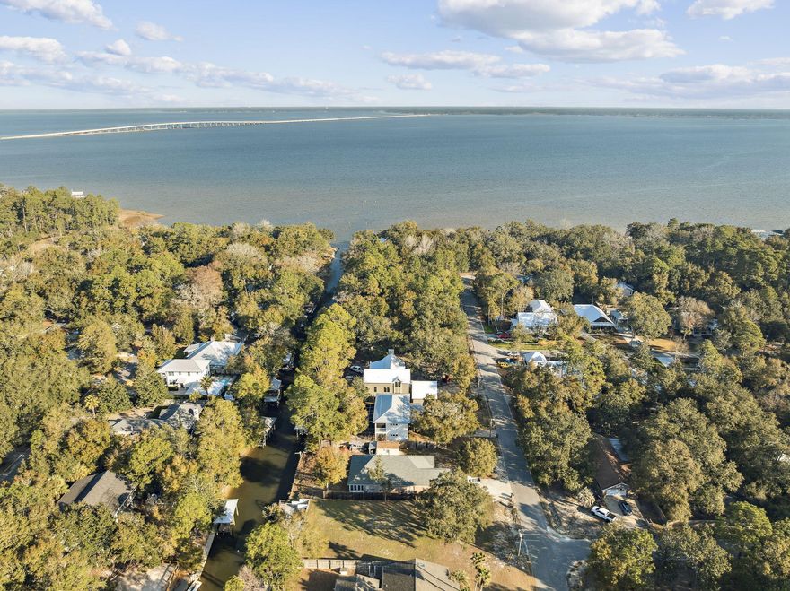 Waterfront living on Baker Canal at 143 Morrison Ave -- with quick access to 30-A shops and restaurants just south on CR 283, and a short boat ride to the Choctawhatchee Bay. The exterior features a dock with boat lift, outdoor fireplace, deck, two storage buildings, Hardie Board siding, and a metal roof. Inside, an open-concept family room and kitchen offer granite countertops, stainless steel appliances, ceramic wood grain flooring throughout, and generous closet space. Three large bedrooms each feature walk-in closets, complemented by 2.5 baths. Raised off grade for added peace of mind.