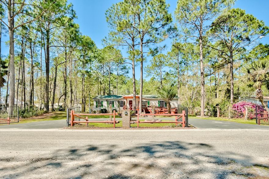 A picturesque setting located on the quiet cul-de-sac road of Holly Pine. 37 Holly Pine is a harmonious plot of land positioned on a large 110' x 190' parcel that offers seclusion with its mature lush landscaping that calls for little attention. This delightful 3 Bedroom 2 Bath Manufactured Home recently had both master and guest bathrooms renovated with stunning tile work. 37 Holly Pine also offers nearly 800 sq. ft. of completely screened-in outdoor entertaining space with a grand 14' x 8' spa and gas fireplace. Other noteworthy features include a gated entrance paired with a horseshoe driveway, electric fireplace, and a 4 Ton Package AC Unit. 37 Holly Pine is conveniently located just minutes from, Publics, Gulf Place Town Center, Ed Walline Beach Access, and Shunk Gulley Oyster Bar. 37 Holly Pine supplies a rare commodity of privacy while being minutes from everything. 