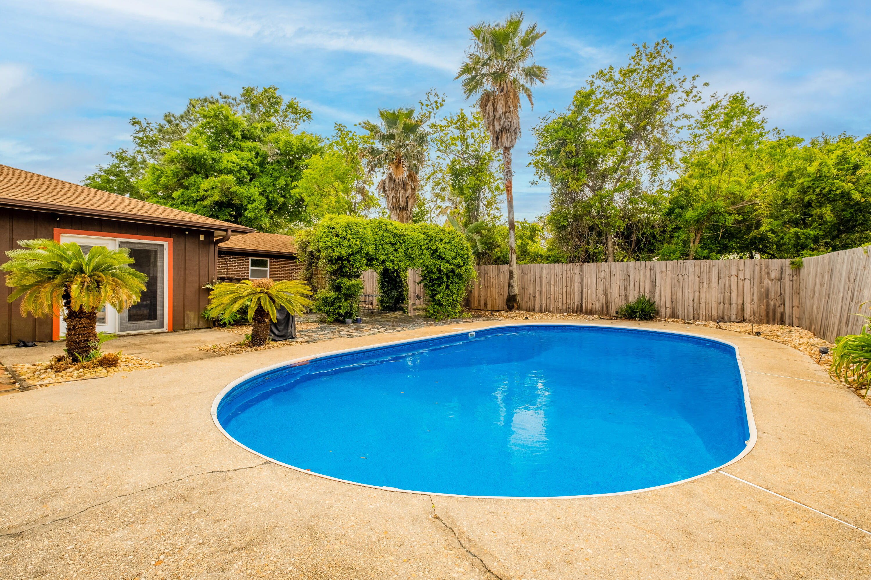 Live where you vacation! Looking for a pool home with outdoor spaces for entertaining and relaxing? This is the home for you! This home will be getting a NEW ROOF. For spending time outside, it has an outdoor bar area and pergola. Must See! No HOA. This home has 4 bedrooms and 2.5 bathrooms with nice size living room areas. Access the pool and outside areas from the master bathroom. No carpet. This home is well maintained. Gas for cooking. Tankless, Gas water heater. Sprinklers with well pump. 0.7 miles from the Oriole Beach boat launch, a 10-minute drive to a National Park with beaches and hiking, and a 15-minute drive to Pensacola Beach. The area allows golf carts to drive legally on designated roads.