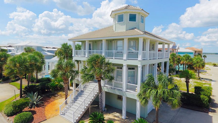 LOWEST PRICED HOME on Navarre Beach! IMMACULATE home on Navarre Beach w/BOAT SLIP. The Village at Navarre is an upscale Sound Front community with Community Pool, Sound Front Beach and Boat Slips. This well maintained home features oversized Great room/Living room with space for dining area, separate dining room that can be easily be converted to an extra bedroom, updated kitchen with extra cabinets and counter space, tiled floor thru out the first level, and wrap around porches with views of the Santa Rosa Sound. In addition to 2 bedrooms and 2 full bathrooms, the upstairs features bunk area for extra sleeping space. The laundry room and the garage both offer plenty of extra storage and space for a golf cart. Located close to Gulf access, Navarre Beach Pier, Bike and Walking trails, this is YOUR DREAM HOME at the Beach.