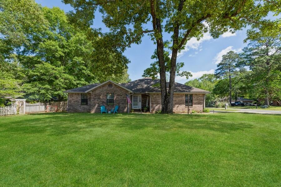 This beautiful three bedroom, two full bath home sits on a corner lot that includes a fully fenced in backyard. The main living space features a wood burning fireplace that is stunning. The kitchen is adjoining to the dining room and offers a refrigerator that is a year old and beautiful granite countertops. The dining room has French doors that lead out to the specious deck in the backyard.This home has a split floorpan. The master bedroom and bathroom offers a lot of space and plenty of storage plus French doors that lead to the back deck.The septic system was installed in 2021 along with a brand new AC unit and smart thermostat!