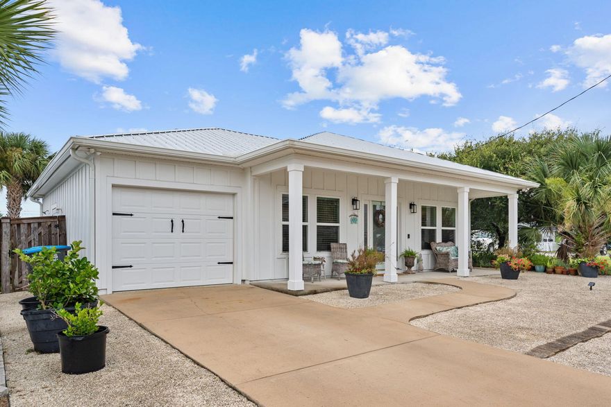 Coastal luxury meets thoughtful design in this custom-built 2BR/2.5BA home by renowned builder Tom Ledman. Professionally designed and styled, it features 9-ft ceilings, tile flooring, and an open layout perfect for beach living. The kitchen offers abundant cabinetry, generous counter space, and a dining area that flows into the bright living room and screened porch with fans, paver patio, and outdoor shower. The primary suite includes a walk-in closet and spa-style bath with walk-in shower, while the guest suite boasts a jetted soaking tub. Additional highlights include a finished garage, full gutters, and designer finishes--all just one block from the white-sand beaches.