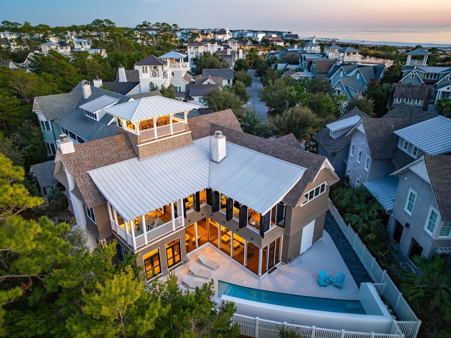 Welcome to your dream coastal retreat at 47 Compass Point Way, nestled in the serene heart of Watersound Beach, Florida. This exquisite residence promises an unparalleled living experience with its blend of luxury, comfort, and breathtaking views and sunsets.  Spread over a generous 4,727 square feet, this pond front home is a masterpiece of design and craftsmanship. From the moment you step inside, you're welcomed by the warmth of hardwood floors that flow seamlessly throughout the expansive interiors. The heart of this home features pecky cypress custom cabinetry that adds a touch of elegance to the gourmet kitchen, perfectly set up for culinary adventures This property boasts 4 well appointed bedrooms, and 5-1/2 bathrooms, ensuring ample space for family and guest alike. Notably, two primary suites offer a private sanctuary with extensive closets and built-in storage spaces. For added convenience, there are two laundry areas catering to each floor. Entertainment and leisure are at the forefront with multiple levels of living spaces. The third floor has a charming bunk/bedroom complete with full bath and wet-bar an ideal haven for younger guests or as a versatile space for hobbies. A slide down to the second level den adds a whimsical touch. Outdoor living is redefined here with a large lagoon style lap pool complete with water feature and plenty of space for lounging. The pool is encased by a concrete privacy wall that makes for perfect sun-soaked days or serene evenings. Screened and covered porches adorned with classic shutters provide the perfect backdrop for alfresco dining or taking in sunsets and gulf breezes.
Additional luxuries include, two fireplaces, reclaimed beams, shiplap walls that add tons of coastal charm. With a three-car garage, parking is never an issue. This property isn't just a home; it's a lifestyle offering tranquility, luxury, and endless sunsets from the tower with 360 views of the Gulf and lake. Discover the meaning of coastal living at 47 Compass Point Way-where every detail has been thoughtfully curated for you to embrace life by the beach in its full splendor. 
 Watersound Beach community is home to one of the area's most beautiful miles of coastline. Amenities include, community pool, puttering park, community green spaces, state-of-the-art fitness center, and deeded beach access. DON'T MISS OUT ON THIS INCREDIBLE OPPORTUNITY in one of 30A's most coveted beachfront neighborhoods. 
** Buyer to verify all dimensions**