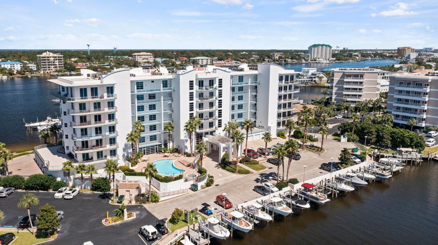 This BEAUTIFUL second floor unit is highlighted by 10-foot ceilings, an open floor plan, a wall of glass sliders, & crown molding in the living area. Tile flooring flows through the entry, living, kitchen, & bathrooms. Granite countertops, pantry, custom tile backsplash, stainless steel appliances & a large breakfast bar in the kitchen. The harbor front master bedroom features a spacious walk-in closet, his and her vanities and walk-in shower. The 2nd bedroom overlooks the pool and canal. Harbor Lights boasts EXCELLENT community amenities, with a common area, paddle board storage, owner's only beachaccess, conference room, gated access, and a beautiful pool.