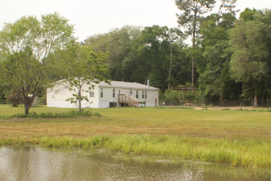 Bring your horses! 16 Acres with a large 4 bedroom mobile home in the country! Mobile home has new roof and new skirting! Pasture with pond and some fencing already in place!