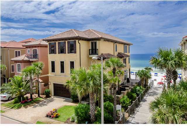 Exquisitely Designed Gulf-front Tuscan Villa with Private Pool in Exclusive Destiny by the Sea. Characteristic of Italian architecture, this well-designed home features umber tones, elegant arches, sweeping classic lines, wrought iron accents, and plenty of alfresco living. Hand troweled wall finishes create the authentic feel of Tuscany. Intricate millwork can be found throughout the three stories of well-appointed interior including premium hand scraped 5'' wide plank Walnut hardwood floors, custom cut Pecky Cypress wood beamed ceilings, custom maple woodwork, and 8 panel 8 foot tall solid alder wood doors. At the home's entry, a wrought iron gate leads to a private courtyard with private pool and hot tub. Tall palm trees, lining one side of the pool, provide privacy. Inside the