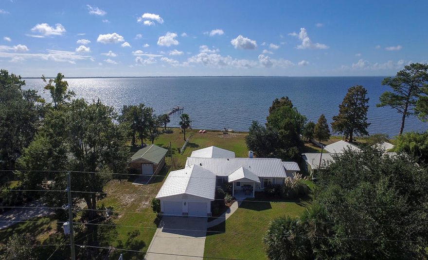 COASTAL LIVING ON THE BAY! Extraordinary Western Sunsets over Choctawhatchee Bay! Popular Bay Grove Road with 90' on the water & a Lot and a Half totaling over half-acre in size. Renovated in 2016, home shows extremely well w/open floor-plan capturing views of the Bay from almost every room in the home! Large Island is the focal point of the Kitchen w/Granite Countertops, Stone Farm Sink, upgraded S/S appliances, recessed lighting, & more. Relax by the Fireplace in Living Area. Two Master Suites, each w/large Master Baths & separate showers. Main Master has two closets & connects to laundry room. New wood laminate flooring. Carpet in guest bedrooms only. Great outdoor deck for grilling & watching the dolphin swim by! Platform dock on Bay for fishing & watching sunsets. Must see!