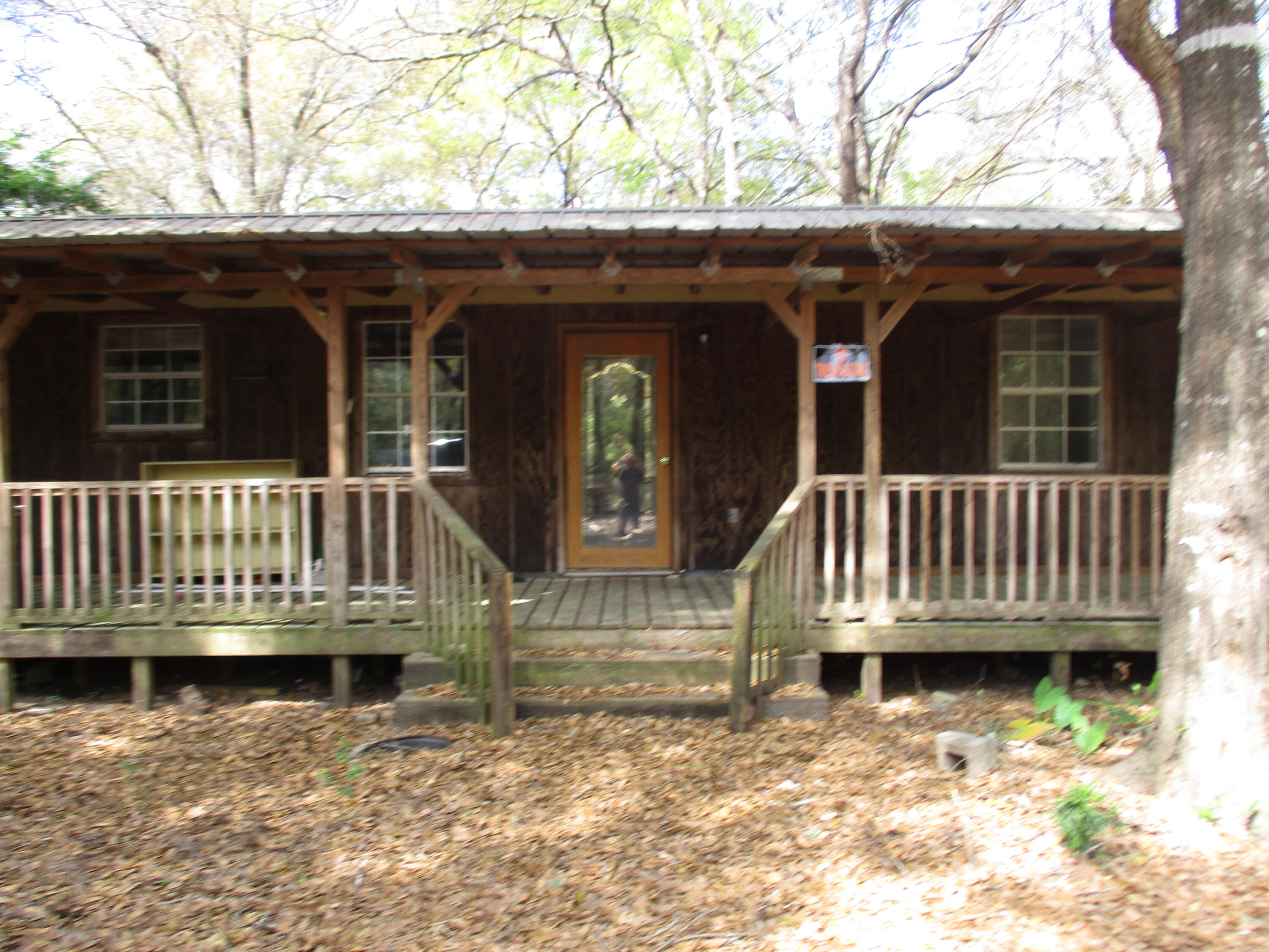 ..One acre lot with cabin. It is 3 bedroom 2 bath It is so private and a cute house If you want privacy this is it. It has a workshop outside. House has new metal roof in 2014. House has been gutted and is almost finished a total remodel inside and out. It will be like a brand new house when finished in a couple of weeks. It is a wow location, lot and house. This house is beautifully done. It is surrounded with very expensive homes in this subdivision.Sq ft is from owner measuring the house.It has a lot of new walls, new waterproof good grade flooring, new bathroom totally other one has new vanity and mirror. All new light fixtures. Newer outside air conditioner which has been tied down. New paint out outside in and out and more.