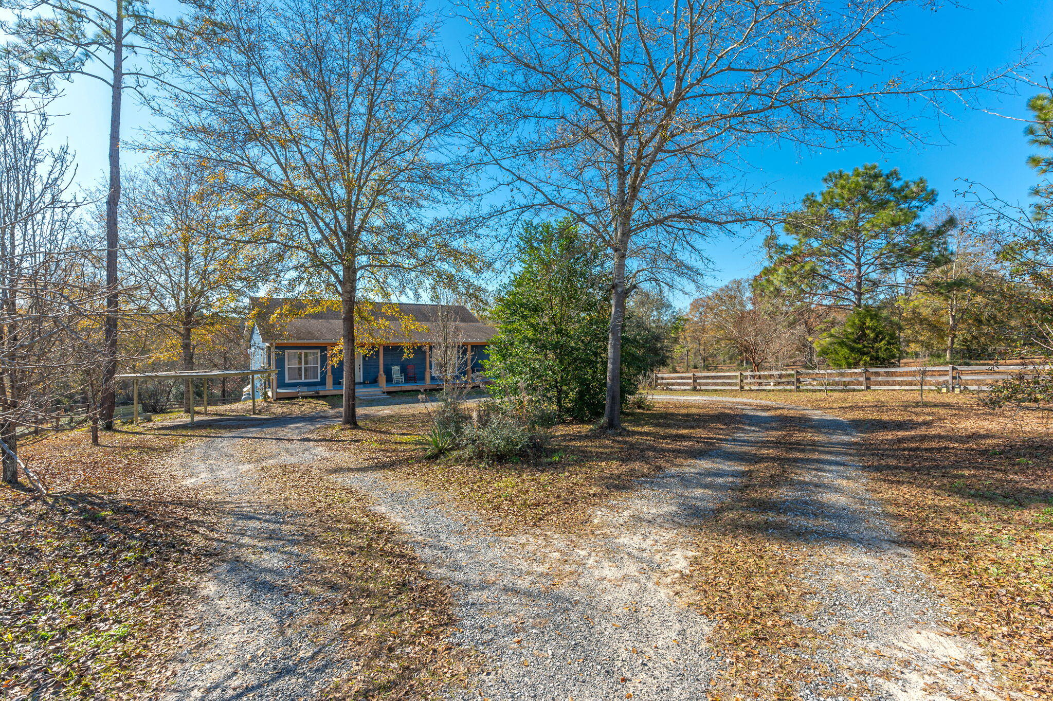 Discover country living in this stunning two-story home. With 5 spacious bedrooms, including three large primary bedrooms each featuring an en suite bathroom, and an additional half bath, this house is the perfect blend of comfort and functionality. The expansive kitchen, dining area, and breakfast nook offer serene views where wildlife will be your morning coffee companions. This 20-acre property includes a charming creek and 10+/- acres fenced, ready for cattle with an electric fence already in place. Wildlife enthusiasts will enjoy regular sightings of deer and turkey, adding a touch of wilderness to your backyard. A large pole barn provides ample storage for farm equipment, while an additional storage building handles all your extra necessities.