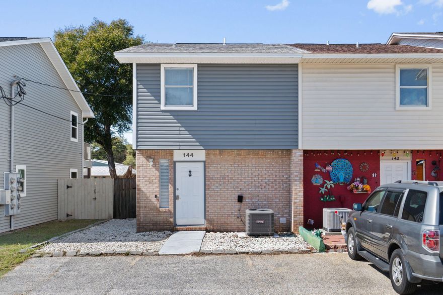 Renovated, fully furnished townhome with no HOA, currently operating as a successful Airbnb and ready for its next owner. Whether you are searching for a short-term rental investment, vacation property, or primary residence, this turnkey opportunity checks every box. The main floor features an updated kitchen, laundry area, and convenient half bath, while upstairs offers two spacious bedrooms and a shared full bathroom. The oversized primary suite includes a large closet and balcony overlooking the backyard. Located just a short walk to the bay, five minutes to the beach, and close to Eglin Air Force Base, this property combines lifestyle, location, and income potential in one smart investment.