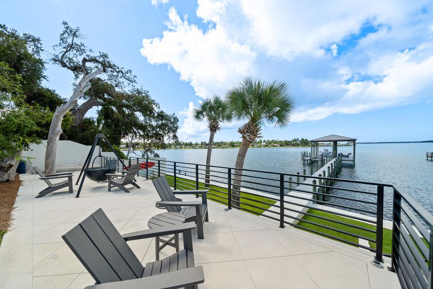 PRICE IMPROVED on this exquisite private WATERFRONT estate, where transitional finishes seamlessly blend with modern luxuries. Situated on over half an acre with 100 feet of water frontage, this home offers unparalleled south-facing bay views and breathtaking sunsets. The lifestyle here is all about the water--whether it's diving into the pool after a day at Shell Island or relaxing on the back patio with a year-round sea breeze.This gated waterfront state ensures ultimate privacy with lush landscaping, a boat dock and lift, pool and 4,189 square feet of living space. Inside, you'll find exceptional finishes, including white oak, oiled-finish hardwood floors throughout, a Chef's kitchen with exquisite water views, and spacious interiors. This home features 3 bedrooms, 4.5 baths, a bonus game room/flex room with wet bar, a 600-bottle, foam-encapsulated and temperature-controlled wine room, and a home office, making it the perfect forever home on the water.

Recently renovated with the highest quality of construction, this contemporary and modern design spans mostly one level, offering expansive outdoor living areas, an incredible boat dock and boat lift, and a luxurious pool. The 2019-built dock is designed for boating enthusiasts, featuring high-end ThruFlow grated decking, a 10k lb Golden boat lift with a covered boat house, low-profile solar lighting, security motion cameras, and ample gear storage.

Upon arrival, a gated entrance with natural native landscaping and the soothing sounds of the Bay welcome you. The outdoor entertaining area includes multiple seating areas, a 36'' Cowboy Cauldron Fire Pit next to the pool, and plenty of space for activities like boating, kayaking, paddleboarding, fishing, and sunbathing. This location is well-known for it's proximity to the new sports complex that residents can enjoy including pickleball, basketball and a dog park. This home is also just minutes from Tyndall Air Force Base as well as a short drive to the World's Most Beautiful Beaches!

As you step into the charming covered entry, you'll be captivated by the meticulous millwork and stunning waterfront views. The great room, with its high ceilings and full-glass windows and doors, leads to covered and open patios where you can enjoy both the pool and the Bay. The Chef's kitchen, located just off the living area, features an oversized island, high end Samsung stainless appliances, and a walk-in pantry. The dining room, open to the living room, connects to a 600-bottle capacity custom wine room, making this home ideal for entertaining on the waterfront.

This estate offers everything Florida's waterfront lifestyle has to offer, making it the perfect sanctuary for those seeking luxury and tranquility. Don't miss this opportunity to live your best life...on the water in Panama City, Florida!
