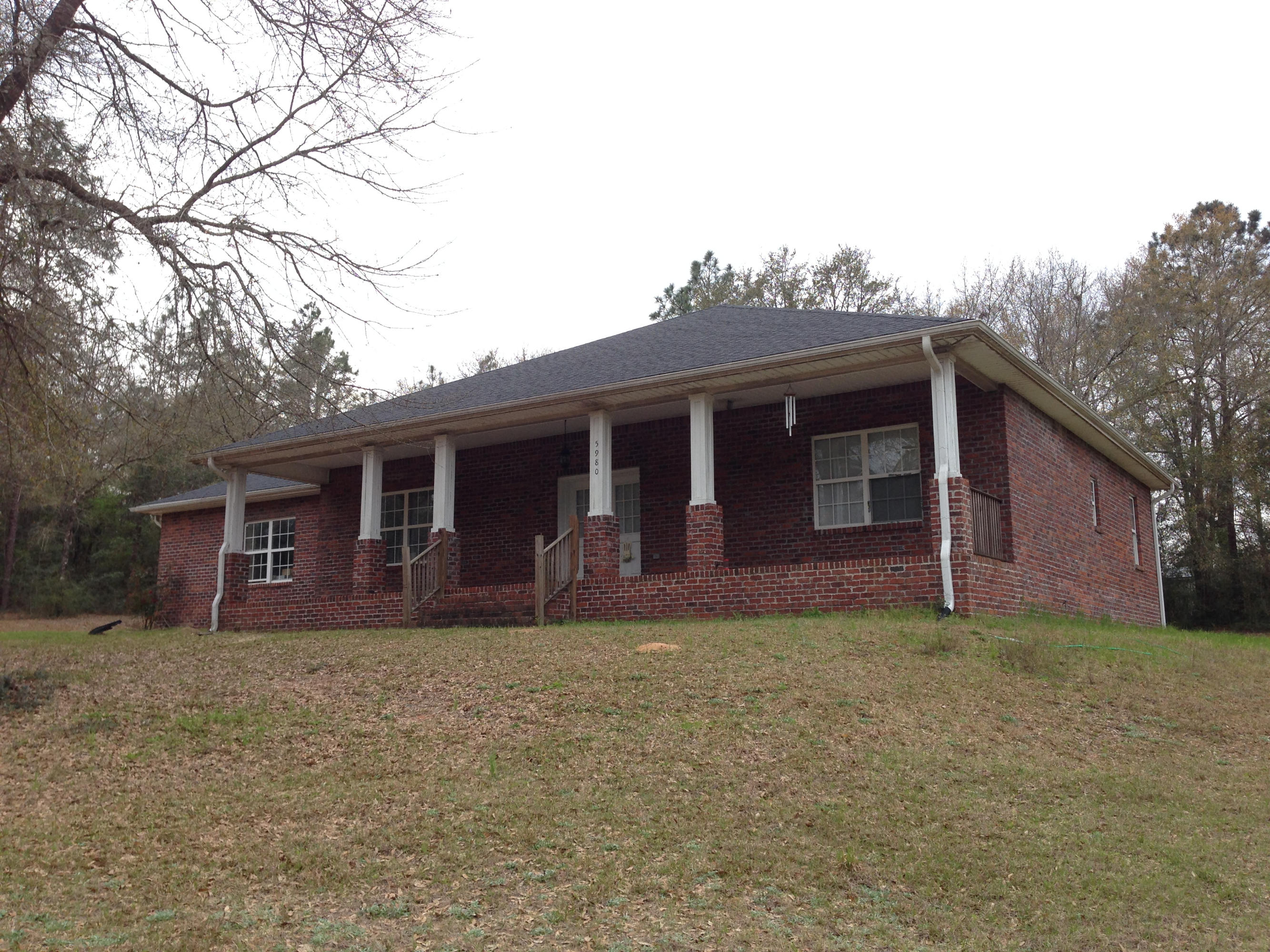 As you drive up to the property, this beautiful brick Colonial style home has white columns lining the covered front porch. As you enter the home, you are greeted by a living room with high vaulted ceilings. The two additional bedrooms and second full bathroom are off the to right in this split floor plan home. Off to your left is the formal dining room with an entrance to your perfect kitchen. Immaculate granite counter tops, stainless steel appliances, and plenty of cabinet space along with a large pantry. There is room for a breakfast table overlooking the back courtyard area. The master bedroom entrance is just off from the breakfast nook. The master bath has a double vanity sink, large garden tub, and separate shower. The laundry room has plenty of storage with a few cabinets.