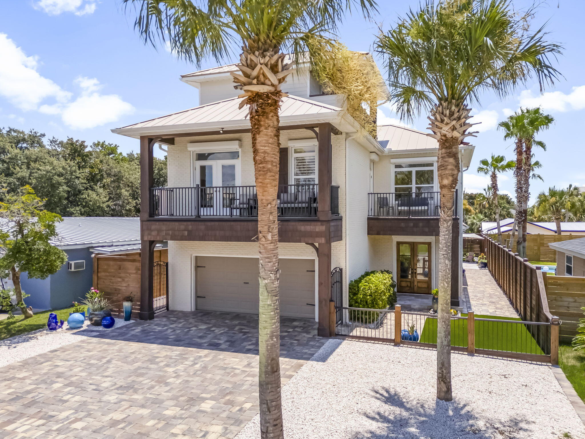 Coastal elegance just steps from the Gulf! 407 Petrel Ave blends luxury and beachside charm with Gulf views from multiple balconies. This 4BR/3.5BA home features soaring ceilings with exposed beams, a chef's kitchen with commercial appliances, wet bar, built-ins, and a stunning primary suite. The backyard oasis includes a heated jacuzzi/pool, travertine tile, putting green, outdoor kitchen, and full bath. With custom closets (even in the garage), lush landscaping, and Bid-A-Wee's private beach access, this home is a true coastal gem--ideal as a primary, second, or investment property.$100 HOA fee include access to a privately maintained, gated beach entrance exclusively for Bid-A-Wee residents