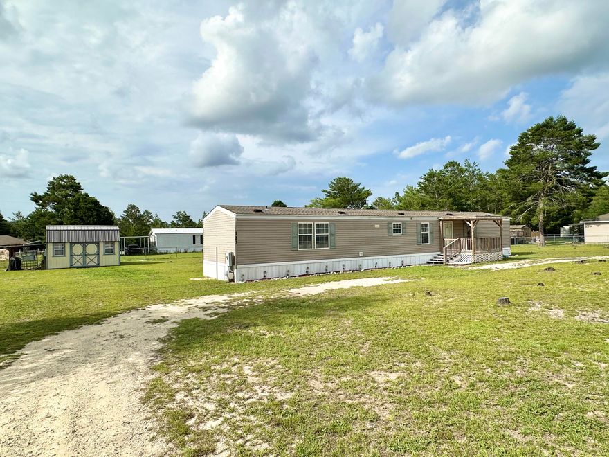 NEW PRICE, GREAT TRIPLE LOT! $1,000 to Buyer at Closing with acceptable offer! Discover comfort and convenience with this manufactured home nestled on a generous triple lot totaling 0.68 acres. Whether you're a first-time buyer or an investor on the hunt for a smart addition to your portfolio, this property delivers value and versatility.. Centrally located between DeFuniak Springs and Crestview. This 3-bedroom, 2-bath home features a concealed laundry area off the kitchen, a newer roof, updated HVAC and hot water heater. Enjoy both front and back covered porches, a chain-link fenced yard, and a detached storage shed with AC and electric ideal for a workshop or additional storage. Plenty of outdoor space for pets, gardening, or future additions. Reach out for a private tour today!
