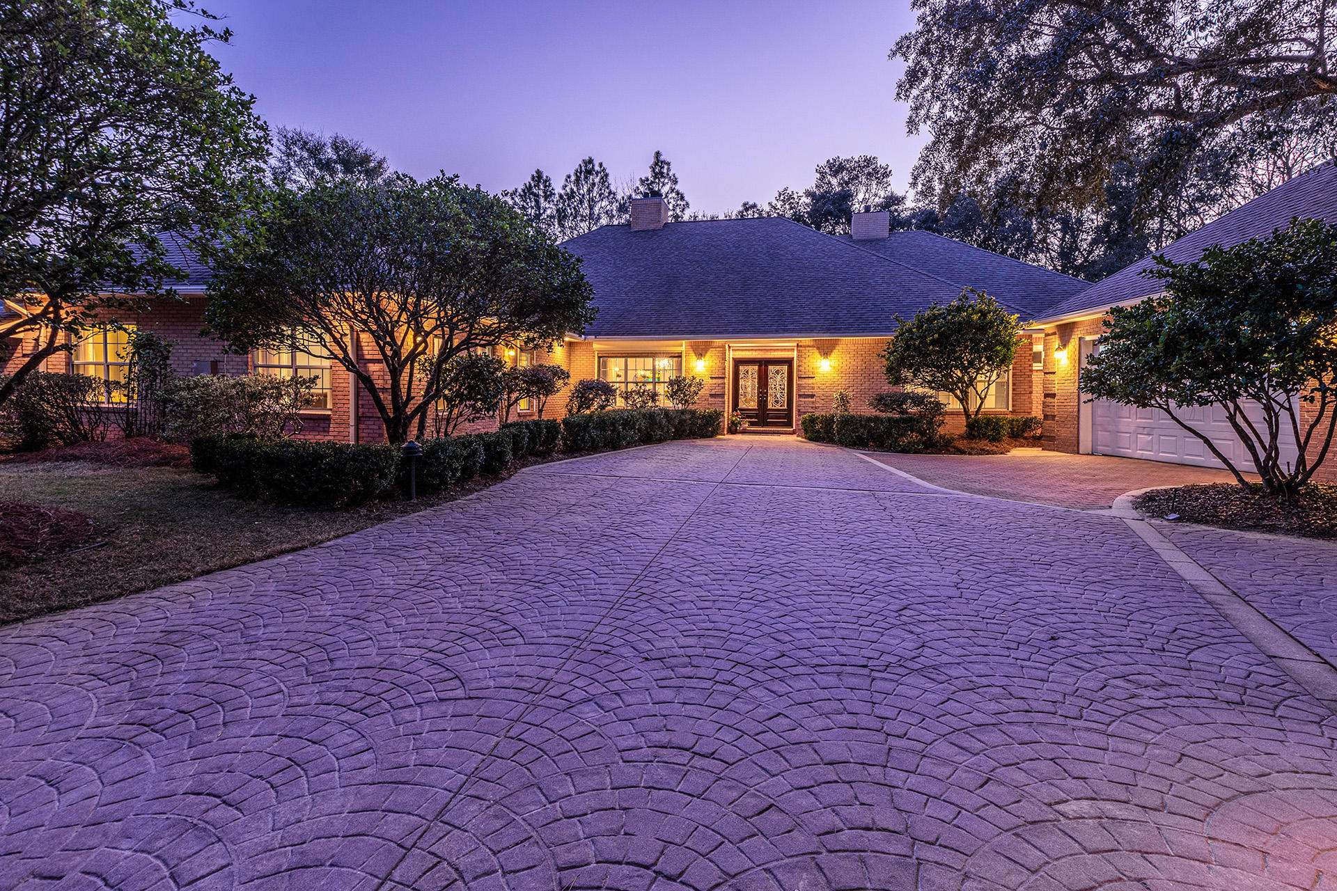 Gorgeous 5 bedroom, 4.5 bath POOL home with newly updated MOTHER-IN-LAW SUITE!Two golf course lots make up this secluded estate in the highly desired gated community of Southwind at Bluewater Bay. As you enter the home, you'll be welcomed by new wood-look tile, and TWO cozy fireplaces in both the living room and dining room. Large eat-in kitchen with stainless steel appliances and gas cooktop. Beautiful master suite with HUGE walk-in closet and REMODELED en-suite bath. Renovated mother-in-law suite comes plumbed for washer/dryer and kitchenette, along with a sloped entry for eased wheelchair accessibility. Spend those hot summer days in your sparkling pool, and enjoy sipping sweet tea in the screened-in patio. This home comes complete with a detached 2-car garage. Easy commute to
