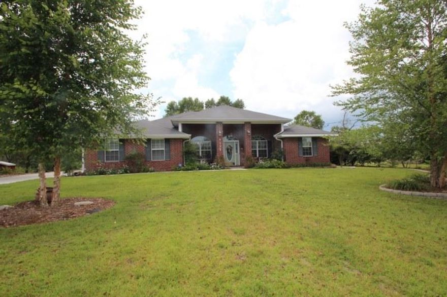 Are you looking for your home away from the hustle and bustle of everyday living? Welcome Home to Mt. Olive Estates. Just outside of Crestview you will find this Incredible home on an acre lot. Beautiful landscaped yard was made for the gardener with posts for displaying your plants. The front covered porch with brick columns awaits for your swing or chairs to enjoy the Florida weather. The front door has gorgeous glass with side lights. Once you enter the home you see the slate tile floors gracing the foyer. To the right of the foyer is the living or office space. To the left is the formal dining room with a chandelier. The whole house has bamboo flooring in all rooms except wet areas. You will enjoy the natural light in this home.