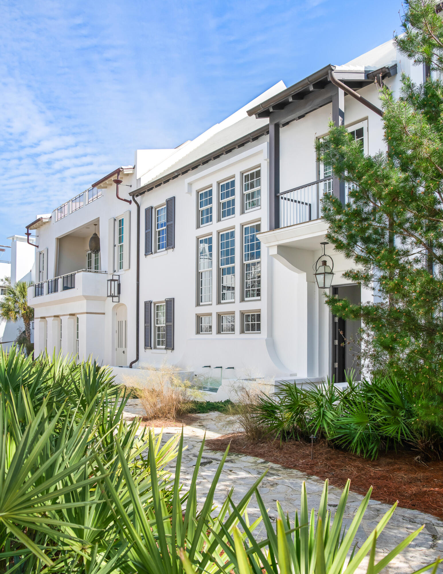 TMc Architecture created the quintessential Antiguan influenced home that Alys Beach personifies, pairing the indoor living with the outdoor. Connectivity begins with the 1st level kitchen, dining, & living rooms that open to the private courtyard hosting an enclosed loggia featuring beverage center, grill, & fireplace. Operable glass doors function to enclose for those chilly evenings.The primary elevation fronts the award-winning Sea Garden Walk pedestrian path creating a special environment for guests to enter the home and easy pedestrian travel to the private owners Beach Club, Caliza Pool, and Zuma Wellness Center. North to Lake Marilyn & the nature preserve or south to the beach by way of Sea Garden Walk. Entering the home draws attention to the ebonized machined steel, floating staircase softened by reclaimed Oak stair treads derived from the same origin as the Oak ceiling beams and flooring. 11' ceiling height paired with full height windows nicely transfers the east to west sunlight throughout the dining, kitchen, & living areas reflecting upon the Venetian Plaster for peaceful ambiance.
The kitchen is appointed with professional appliances centered with a large marble island looking upon the dining & living area. For work interruptions, an office located privately off the kitchen is available for such. Outdoor entertaining is achievable having the outdoor covered loggia adjacent from the kitchen leading to the courtyard open to the sky. Guests will be enamored by the uses of the private outdoor gathering spaces.
55 Hog Penny Alley boasts 4 bedrooms plus a double bunk room to accommodate family & friends. The primary bedroom suite is exclusive capturing privacy that opens to a personal roof terrace for those moon lit nights. In addition to, the primary has a private stair hall with direction to the home's glass, enclosed studio providing refuge as a media room, secondary living room or for a Zen yoga studio.
The 3 guest suites & double bunk rooms are opposite to the primary bedroom for timely separation and privacy. Tastefully appointed bathrooms to suit.
Additionally, this property provides a two car garages plus walk-in owners closet with 2nd refrigerator and additional storage closets for beach accompaniments and the like. Furnishings convey with the sale. This home is a must see and ready for immediate occupancy.
