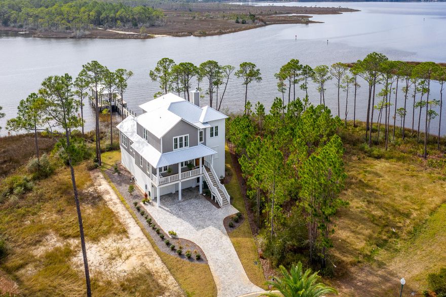 Astonishing south-westerly sunset views characterize this one-of-a-kind waterfront retreat. Situated on beautiful Hogtown Bayou, this custom designed home creates the perfect haven for the unspoiled lifestyle. Featuring 119 feet of waterfront footage, this property boasts a large open concept great room emphasized by a spacious chef's kitchen, vaulted ceilings, reclaimed solid wood beams, and distinctive venetian plastered gas wood-burning fireplace. Offering 5 bedrooms, 3 full bathrooms and 1 half bathroom; 55 Teal Court is the ideal home for entertaining family and guests. The chef's kitchen features a Thermador gas range, Thermador 36' built-in refrigeration, farm-house sink, quartzite natural stone countertops and a walk-in pantry with microwave and beverage fridge.