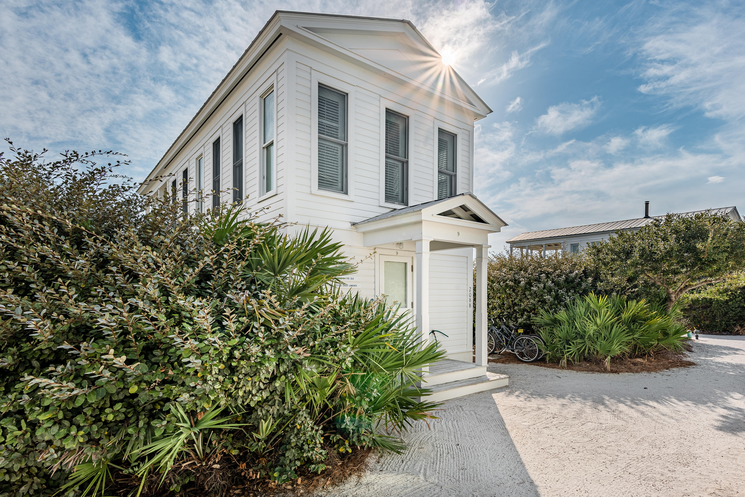 Here is an opportunity to own one of Seaside's original ''Honeymoon Cottages''. This hidden gem is tucked away amongst a thick grove of dune oaks exhibiting the world renowned charm of Seaside. As you enter this beachfront cottage, the all white wood painted interior welcomes you with its simplistic warmth. The first floor master bedroom opens to a private screened-in porch with an outdoor whirlpool tub and peaks of the Gulf through the dune oaks. The master bathroom boasts a huge steam shower and beautiful tile floors. Upstairs you will find an open concept floorplan with kitchen, living and dining space that opens to a covered porch with gorgeous gulf views. Enjoy the gulf breezes and dine under the stars from the upstairs porch or admire the exquisite architecture of the Pensacola