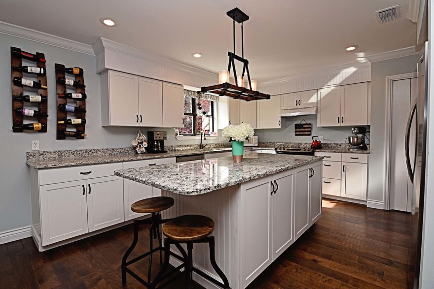 Beautiful 3bed/2bath 2088 sq/ft + FL room, home in Bluewater Bay. From its lovely landscaping to it's interior details and upgrades, this home is a gem! Recent upgrades include engineered hardwood flooring throughout; Newer HVAC, upgraded tile in bathrooms; industrial-farmhouse light/fan fixtures; and white shaker kitchen cabinets, granite counter-tops & stainless appliances; just to name a few! This home's ''open floor plan allows for comfortable living on a daily basis, and effortless flow when it comes to entertaining''. Living area's beamed cathedral ceiling ''makes the room feel incredibly spacious, but a quaint fireplace gives it a homey feel''. Kitchen sports: classic white cabinets w/ more than enough storage, granite counter-tops w/ plenty of ''prep-space''