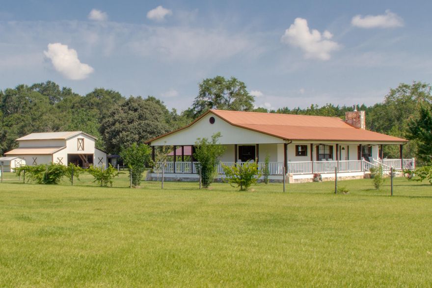Sit on one of the rocking chairs, on this homes wrap around porch and enjoy the view of the pond, while horses graze in the pasture having just finished their breakfast in one of the areas nicest 2 story horse barns. This country home enjoys a new copper roof, and air handler, and was designed and built with cathedral ceiling, large stone fireplace, lots of hardwood floors and large his and her walk in closets in the master bedroom. This property is meticulously maintained with exquisitely groomed oaks and pecan trees, various berry trees including fig, blackberry, and grape, while red maples and Japanese Cherry trees adorn the front yard. The pond is stocked for excellent fishing.