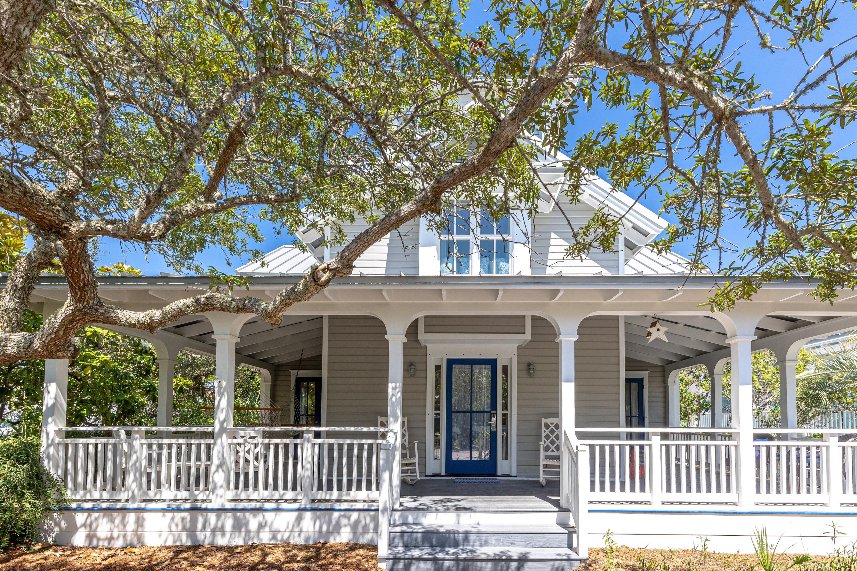 Prominently located on the corner of Odessa Street and 30A and just a few steps to the beach or downtown Seaside. This beach retreat begins with a full wraparound porch sheltered by lush native vegetation, a gracious conversation area. As you step inside the foyer the coastal personality of the cottage unfolds to start your relaxed living at the beach. On either side of the center hall are two guest bedrooms, each with private bath. The master suite is positioned at the rear of the house for privacy. The master bath includes double vanity, whirlpool tub and separate shower. Outside shower, laundry room and a shuttered porch that provides a retreat to escape with your favorite book or take a quick nap are also located on the first level. Soft colors of the interior and natural finished wood floors continue up to the second level. Three sets of French doors from the living and dining areas lead to porches with gulf views, one covered for outdoor dining and another uncovered porch wraps around the living area. The kitchen is arranged for efficiency, outfitted with breakfast bar and all the tools the family chef needs to prepare a picnic for the beach or family dinner. Dining area with raised ceiling is adjacent to the kitchen. The living area with vaulted ceiling is furnished with comfortable slipcovered furniture to gather at the end of the day. Full bath also on second level. On the third level is the enclosed tower with sitting area and twin bed. Tall windows surround the tower to take full advantage of views of the emerald green color of the gulf or our amazing sunsets. Search for shooting stars from the balcony. Main house has room to enlarge. The guest cottage accommodates extended family or guests.