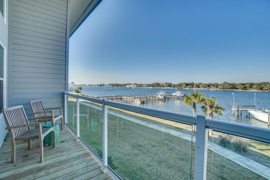 PRICE IMPROVEMENT!! Offered fully-furnished and turn key ready, this immaculately kept townhome is ready to serve as your rental property, second home or primary residence! This waterfront home on the sound is just  2 blocks from the beach featuring 3 bedrooms, 2 full and 1 half bathrooms, and a bonus room located on the second floor perfect as a bunk room or home office.Boasting expansive views of the Intercoastal Waterway this property exudes coastal luxury with it's modern style, deeded 28'x12' boat slip and community pool. Other notable features include an attached garage, high-impact windows & doors, metal roof, granite surfaces throughout, stainless steel appliances and high-end furnishings & decor. Being newer construction, all appliances and systems are only 4 years old.