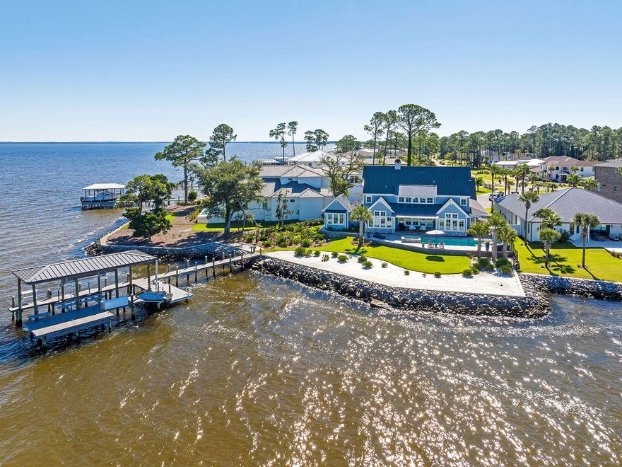 37 Driftwood Court is a Watersound-inspired mansion tucked in the center of a quiet, five-home cul-de-sac and offers the kind of privacy that's hard to come by in this area - while still being just minutes from Grand Boulevard, Topsail State Park, and Scenic Highway 30A. The home greets you with a floorplan that opens up immediately: 20-foot ceilings in the great room are framed by floor-to-ceiling windows that flood the home with natural light, waterviews, and sunsets along the Choctawhachee Bay. The layout was made for hosting and the uniquely wide lot creates a floor plan that sprawls & gives each space a sense definition & flow. The open-concept main level comfortably accommodates up to 40 guests, and the kitchen sits right at the heart of it all, as any good kitchen should.  It features a 48" Wolf dual fuel range, Sub-Zero refrigerator, two dishwashers, and a walk-in butler's pantry with a wet bar and ice makereverything you need to entertain without missing the moment.
The primary suite is located on the first floor and the builder perfectly positioned it with commanding sunrise & sunset views on the water. Its spa-like ensuite bathroom comes complete with an infrared sauna, wet room, soaking tub, two walk-in showers, and a heated bidet. A California closet and a private sitting area with panoramic water views rounds out the space. A private door from the sitting room opens directly onto the screened-in pool deck.
Upstairs, two guest suites offer ensuite baths, and a newly added mother-in-law wing brings even more flexibility. It includes a brand new spacious flex space that can be a bedroom, gym, or home office. A brand new bathroom with a walk-in shower & a large additional suite with a newly constructed wet bar with a pot filler and wine cooler complete the space. 
Outdoor living is centered around the heated saltwater pool and spa that overlooks the private, white-sand beach where you can enjoy 180-degree views of both sunrise and sunset. The outdoor area also includes a natural-gas outdoor kitchen & a covered sitting area with a remote-control screen that drops down at the press of a button.
 The large 2-car garage has epoxy flooring and an extra 5'x10' bump-out that's perfect for storage or golf cart parking. The garage also has a GM fast charger for electric vehicles. The driveway can easily accommodate up to seven additional cars. 
