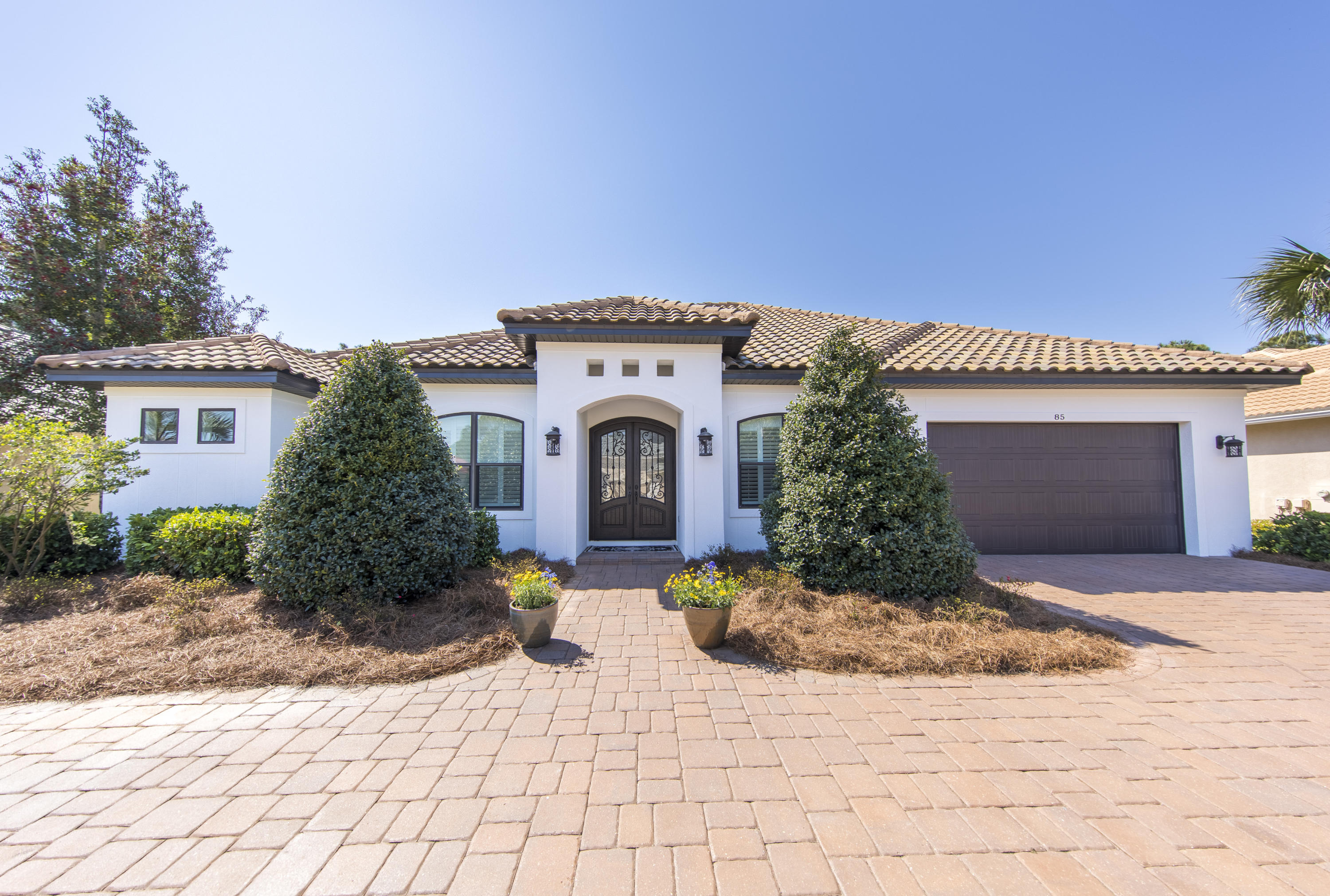 Custom Home on the 17th Fairway in the Gated Community of Emerald Bay. Relax on your covered porch with fireplace, summer kitchen, heated pool and spa. Home also boasts 10' ceilings, 2x6 exterior walls, R-19 BIBS wall insulation and hurricane rated impact windows along with 8' interior and exterior doors. Wonderful kitchen with twin islands, double oven and built in ice maker. Water purification system new brick paver patio and automatic lights make this a must see.