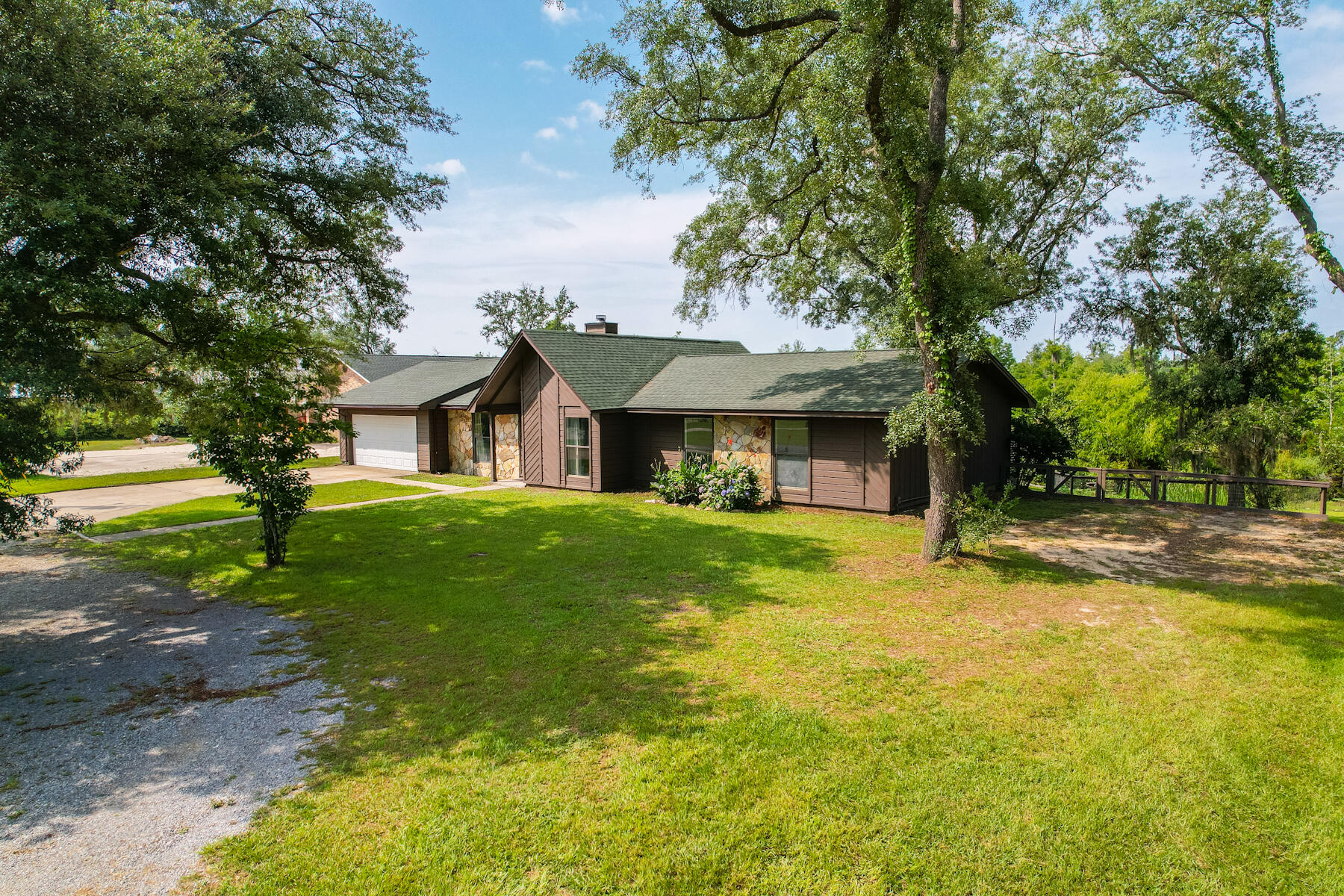 'CURRENTLY UNDER CONTRACT, SELLER WILL CONSIDER BACKUP OFFERS' Your porch overlooking the water is waiting on you in this updated 3 BR 2.5 B Deerpoint waterfront home. It has so many great extras. In addition to a cozy Deerpoint cove location, this 3/4 acre property has a large airconditioned workroom area, a separate storage or garage building AND a boat house. There is storage galore. Large kitchen with eat in area and separate dining area. Large primary bedroom with it's own shaded deck area. Great room area has a fireplace and vaulted ceiling. Come see this perfectly priced waterfront home. New roof post Hurricane Michael.Property is in flood zone X.