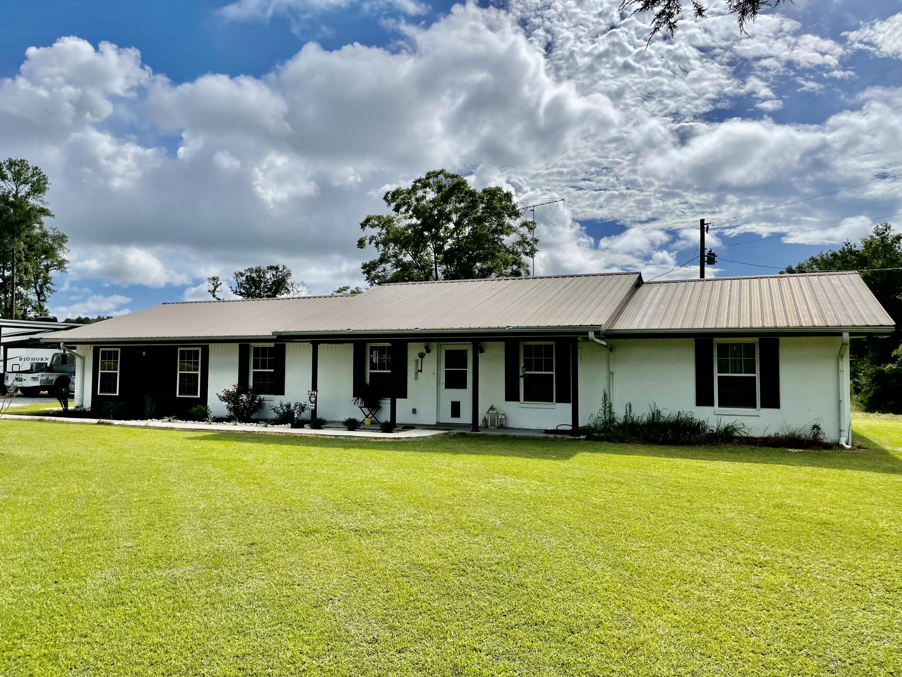 Welcome home to this spacious 4 bed/3 bath house on 12.4 acres. Home was completely remodeled in 2017 to include new plumbing, wiring, HVAC, and insulation. Walking through the front door you'll find a completely open concept between the living, dining, and kitchen. Living room has wood burning fireplace. Kitchen is outfitted w/ stainless fridge & stove, a copper farmhouse sink, and leathered quartz counter tops. This split floor plan has the the spacious master and master bath just off the kitchen. Master bath has a soaking tub, stand up shower, and its own entrance from the back patio. An additional 3 bedrooms and 2 baths are down the hall on the other side. One of the additional bedrooms has its own personal full bath. Home has vinyl plank flooring throughout & a propane tankless water
