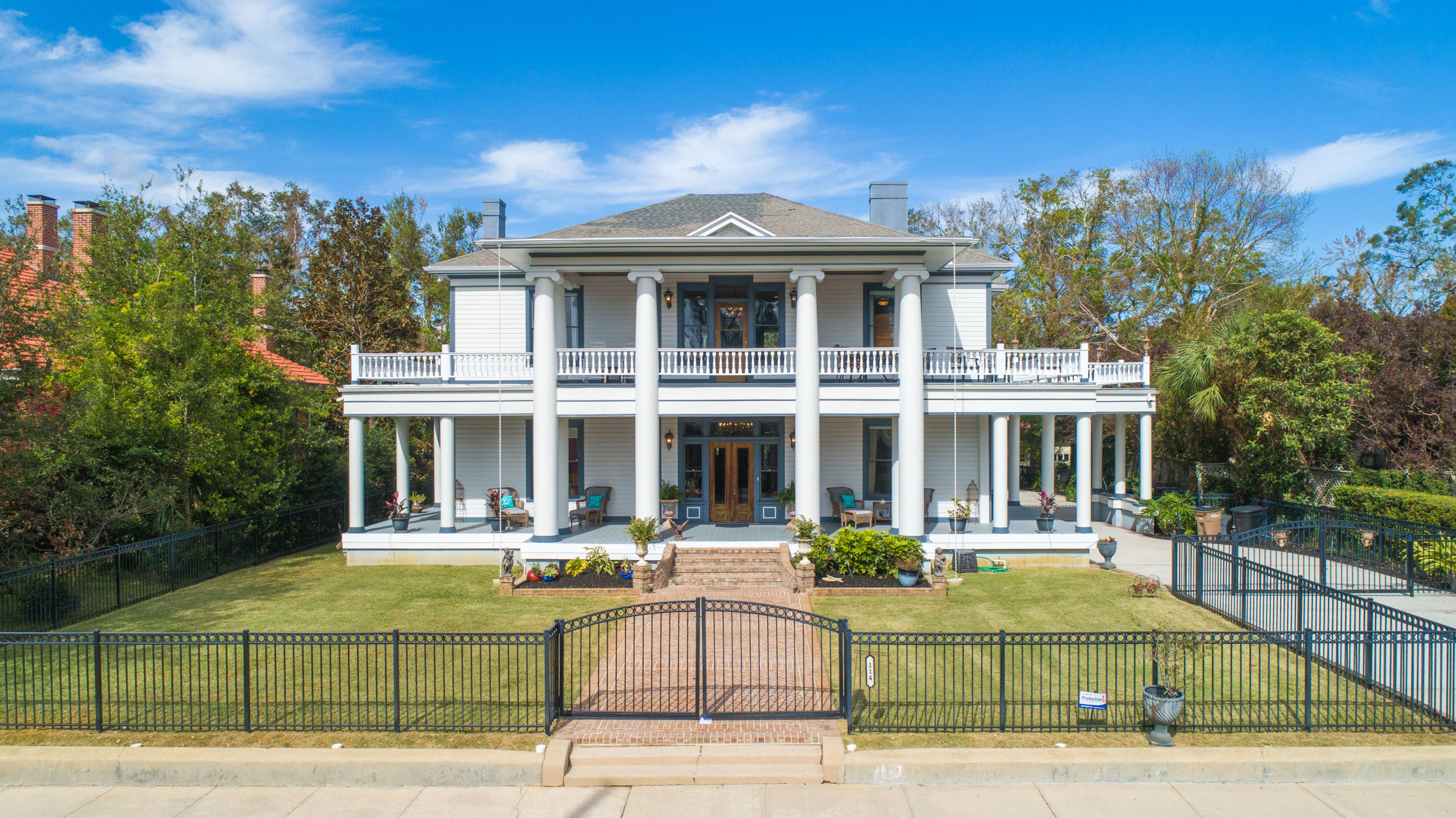 Constructed in 1908 by the Sublett Family, this exquisite Neo-Classical Estate has been fully restored to it's original grandeur with no detail spared. After falling into disrepair and purchased by it's second homeowners in 2004, 4 full bathrooms and a powder room were added as well as a fully renovated kitchen. All porches were reconstructed as well as all new plumbing and wiring installed. This home is perfect for entertaining with a parlor with wet bar, living room, formal dining room with butlers pantry with wet bar and ample outdoor living space on two levels that encompass the home. You'll note the incredible craftsmanship, fully restored wood detail and beautiful hardwood floors and pocket doors as well as 9 fireplaces with original tile work and elegant chandeliers throughout the h