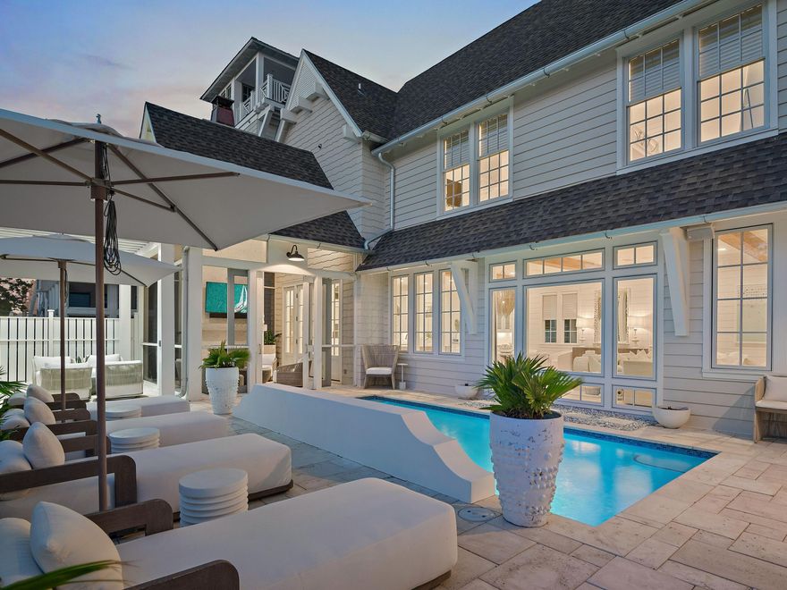 Welcome to 132 Grace Point Way, a masterfully designed coastal retreat that perfectly blends elevated architecture, privacy, and the effortless elegance of life along 30A. Nestled within the exclusive gates of Grace Point, this residence offers 5 bedrooms, 5.5 bathrooms, and more than 5,000 square feet of thoughtfully curated living space. Perched to capture sweeping Gulf views from multiple levels, the home also provides the rare privilege of direct private access into the Watersound Beach Club, placing world-class amenities and sugar-white sands just steps away.Designed by TS Adams and completed in 2019, the home radiates timeless craftsmanship and modern coastal charm. Vaulted wood-beam ceilings, gleaming marble accents, and hand-selected finishes create a setting both refined and inviting. Every room has been furnished with the highest level of care, featuring luxury pieces from Palecek and Restoration Hardware, handmade light fixtures, and sumptuous linen bedding. Offered fully turn-key, even the artwork and custom details remain, ensuring a move-in ready experience curated for the highest level of luxury living.
Outdoors, the property was conceived with both privacy and indulgence in mind. A private heated pool with Gulf views anchors the backyard, seamlessly blending with the open-concept interior for true indoor-outdoor living. The exterior was refreshed in 2023 with a crisp Nantucket-inspired palette, complemented by upgraded landscaping, architectural lighting, a pet-friendly run, and an outdoor kitchen perfect for entertaining. Smart home features, a Sonos audio system, and a humidity-controlled garage further elevate the lifestyle.
Comfort is paramount, with two primary suites, a custom bunk room, and two additional bedrooms ensuring ample space for family and guests. A personal sauna, elevator servicing all three levels, and dual laundry rooms bring both luxury and convenience. The third-floor bonus room offers endless flexibility, whether envisioned as a media lounge, studio, or quiet retreat.
What truly sets this offering apart is its unparalleled location and access. Grace Point is a private, gated community with a dedicated owners' gate leading directly into the Watersound Beach Club. Here, members enjoy a resort-style experience unmatched along 30A, with two expansive zero-entry pools, over 1,000 feet of private sugar-white sand beach with full chair and umbrella service, and a selection of beachside dining venues including indoor and open-air options. The club also offers pickleball and tennis courts, a state-of-the-art wellness center, water sports such as paddleboarding and kayaking, and a calendar of member-only events designed to enrich every season. Whether you stroll home from a day at the beach or take a short golf-cart ride to nearby Camp Creek for a round of golf or spa-level fitness, life here is nothing short of extraordinary. 
132 Grace Point Way is more than a home, it is an invitation to a lifestyle defined by beauty, comfort, sweeping Gulf views, and the rare privilege of direct access to one of 30A's most coveted private beach clubs.
