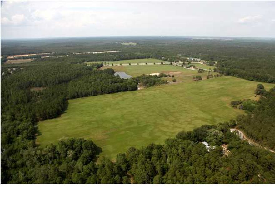 A prime 23-acre parcel offering (70) units of single-family density with secured entitlements. The parcel is located just South of Passages at Hammock Bay on the West side of the main thoroughfare, Great Hammock Bend. Hammock Bay is Northwest Florida's most sought after affordable master-planned, bayfront community! Located just 12 miles north of the gorgeous beaches of the Emerald Coast, the exceptional 3000 acre community was planned and developed by one of the areas most renown developers. Painstaking attention was used in planning the community to be the ultimate home for a demographic demanding a more affordably priced, full amenitized community. Over 1/3 of the community is greenspace.