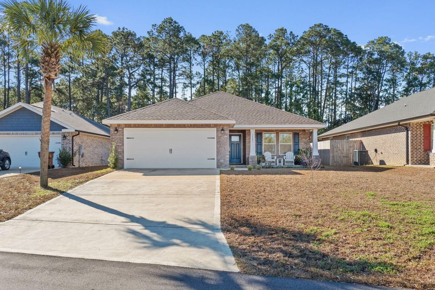 Welcome home to this stunning and better than new home on a 0.32 acre lot with no HOA! Built in 2021 this all brick 3 bedroom 2 bath brick home offers exactly what you are looking for with the high end finishes you want. Enjoy an open living room with a soaring vaulted ceiling and recessed lighting open to the dining room and kitchen space adorned with luxury vinyl plank flooring. The kitchen features solid wood cabinets with soft close doors and drawers and granite counters as well as drop down pendant lighting and brushed nickel hardware. You will love this owner's suite featuring a door out to the screened in patio and a trey ceiling with accent lighting! The owner's luxurious bathroom is a dream with a separate garden tub, a walk in tiled shower with dual shower heads, double vanities with granite counters, a private water closet, and two walk in closets! The other two spacious bedrooms with ample closet space are located on the other side of the house with a shared full bathroom between them. The interior laundry room is off the kitchen and leads to the two car garage. Outside you will love the screened in covered patio with a nice private view and no backyard neighbor. The backyard has a privacy fence and the property line extends past the fence line! Don't delay on this gem, enjoy being a short drive to Hurlburt Field and only minutes to Navarre Beach! 
