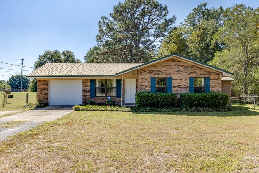 This charming 3-bedroom brick home is nestled on a spacious 1.01 acre corner lot! Ideal for anyone looking for peaceful living with room to grow.Step inside to find a comfortable layout with updated carpet installed in 2022. The kitchen has a great view of the backyard! The bathroom features a tiled walk-in shower, adding a modern touch to this classic home. Outside, you'll love the large fenced in backyard -- perfect for gardening, play, or simply enjoying the Florida sunshine - there's even an additional fenced area for pets or chickens perhaps and side shed! The 1-car garage provides convenient parking and backyard access. Located in a quiet Crestview neighborhood, this property combines privacy and space with easy access to local shopping, dining, and schools.
