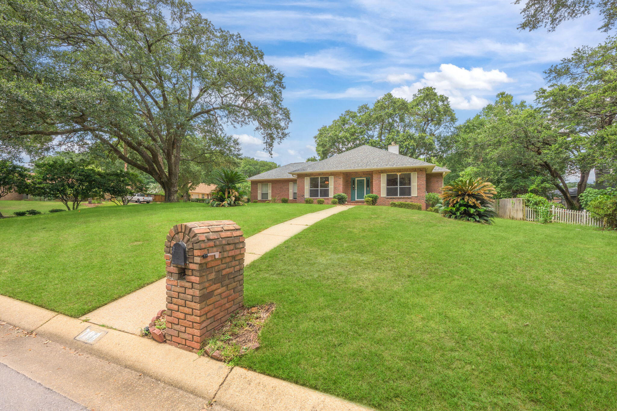 This all brick, well laid out home is nestled in the adorable neighborhood of Copper Ridge Estates. Situated on an elevated corner lot, the property is surrounded by mature shade trees and lush landscaping giving it fantastic curb appeal! With three bedrooms and two bathrooms, the home offers a functional layout and numerous updates. Recent improvements include a 2024 roof, new gutter guards, brand new flooring, and fresh neutral paint throughout. The bright living room is filled with natural light and overlooks the peaceful backyard and spacious deck. A new wood-burning fireplace with a custom wood mantle adds warmth and character, flanked by built-in bookcases for added storage and charm. The dining area and breakfast nook are open to the living space, creating an easy flow for everyday living and entertaining. The kitchen is tucked in the center of the home, featuring a pantry and plenty of cabinet space. The private primary suite is located at the rear of the home and includes a walk-in closet and an en suite bathroom with double vanities, a jetted tub, and a separate shower. On the opposite side of the home, you'll find two additional bedrooms and a full bathroom situated between them. Out back, the large open deck is shaded by large trees - perfect for grilling, entertaining, or relaxing in the peaceful surroundings! This home is conveniently located just minutes from NAS Pensacola and I-10, so you'll enjoy quick access to both the base and major commuting routes. With its updated features, thoughtful layout, and ideal location, this home in Copper Ridge Estates has so much to offer!