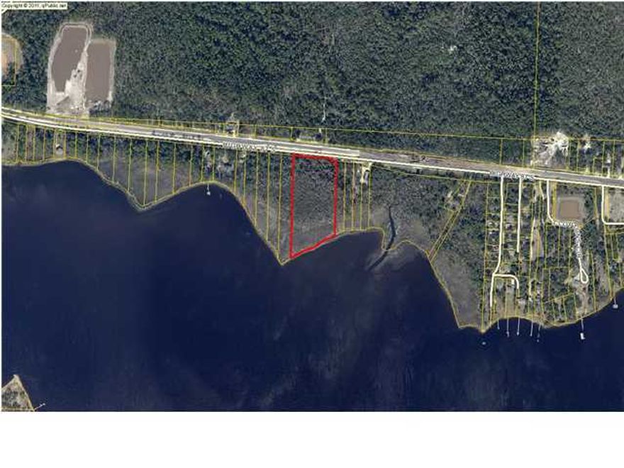 Very large Parcel. Tax Records say 469 feet of frontage and 8.151 acres. Bank owned property and buyer to verify all dimensions. Must use Hancock Bank Contract. Wet lands present, buyer to do own due diligence.