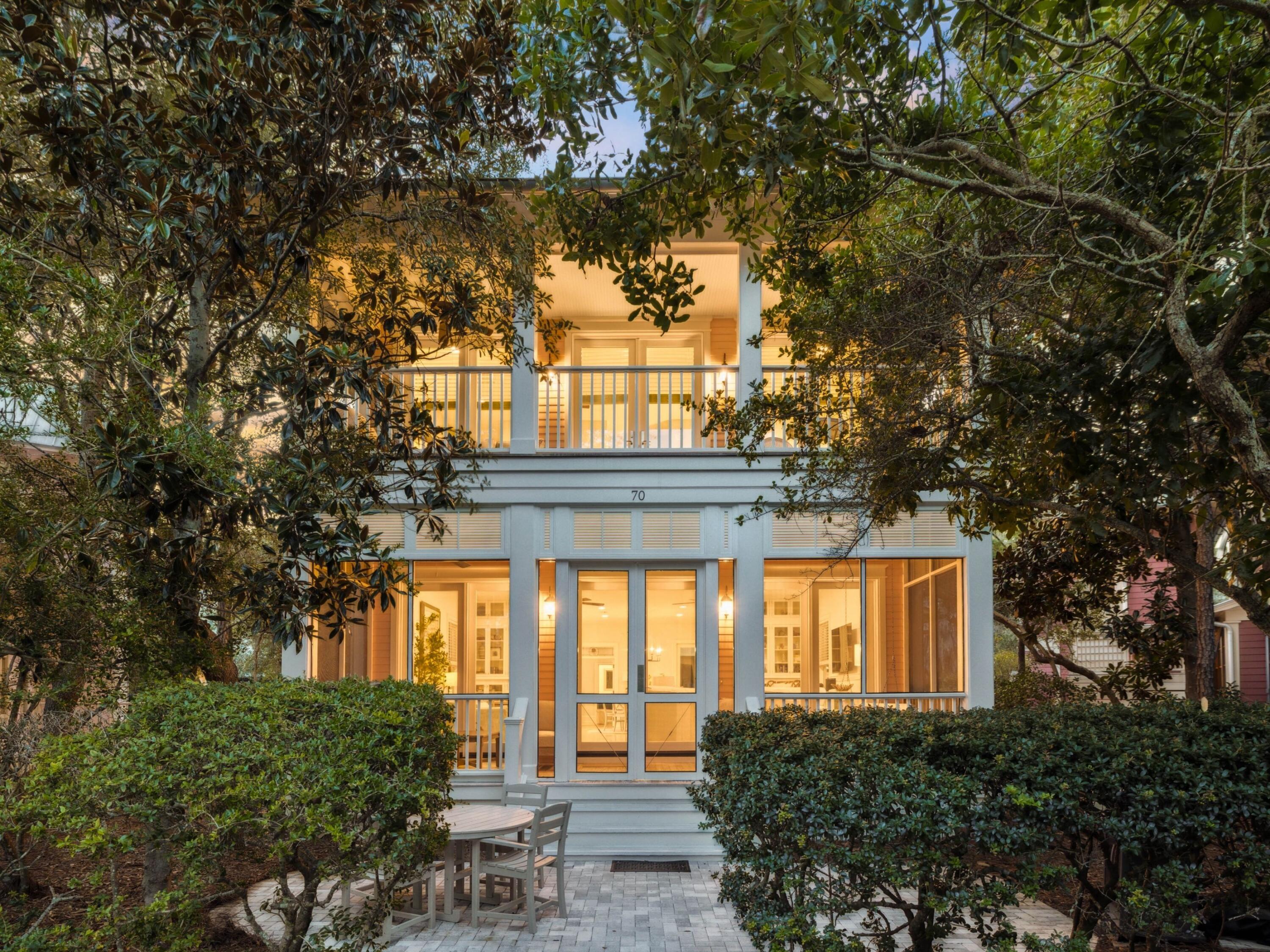 Tucked away in the coveted Park District of WaterColor Phase I, 70 Sunset Ridge Lane is light, bright, and open, having undergone a complete remodel in 2021 to pair the charm of classic coastal architecture with thoughtful modern updates. Located in the intimate Rose Garden Mews, one of only twelve homes encircling the lush and peaceful Crimson Park, this residence offers a rare blend of privacy and accessibility. Designed to bring the beauty of the outdoors inside, the home's serene setting is complemented by its proximity, less than 1,000 steps, to the WaterColor Beach Club, the WaterColor Hotel, and Marina Park, and within easy walking or biking distance to tennis courts, Camp WaterColor, and Seaside. On the main level, a spacious open-concept living, dining, and kitchen area creates the perfect space for entertaining and everyday enjoyment. A guest bedroom with a private en suite, a convenient powder room, and a generous screened-in front porch overlooking Crimson Park provides both comfort and functionality.
Upstairs, the primary suite boasts a private, covered balcony with park views, providing a serene setting to start or end your day. Two additional guest suites each feature en suite baths, while two upstairs sitting areas offer flexible spaces for lounging, working, or even adding a bunk room if desired.
The renovation included full bathroom updates, fresh interior paint, and a tankless water heater. All windows and doors were replaced with hurricane-impact-rated versions, enlarged to increase natural light, and hurricane shutters were added to every window. The property also benefits from access to four HOA-dedicated parking spaces, a rare and valuable amenity in this prime location.